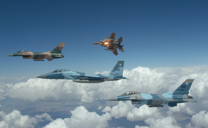A flight of Aggressor F-15 Eagles and F-16 Fighting Falcons fly in formation over the Nevada Test and Training Ranges on June 5, 2008. The jets are assigned to the 64th and 65th Aggressor Squadrons at Nellis Air Force Base, Nev. The Aggressor mission is to prepare the combat air forces, joint and allied aircrews for tomorrowÕs victories with challenging and realistic threat replication, training, academics and feedback.
(U.S. Air Force photo/ Master Sgt. Kevin J. Gruenwald)