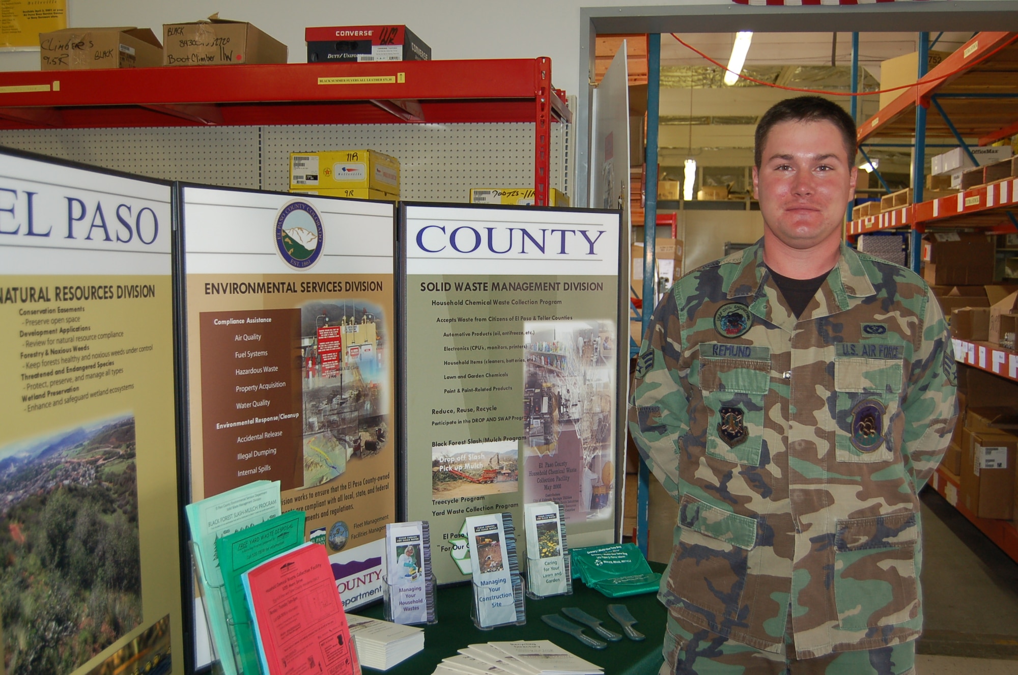 Senior Airman Heith Remund, an electrical systems specialist with the 21st Civil Engineer Squadron, poses in front of a display at an environmental expo June 3. Airman Remund has taken small steps to live a greener lifestyle. (Air Force Photo by Corey Dahl)