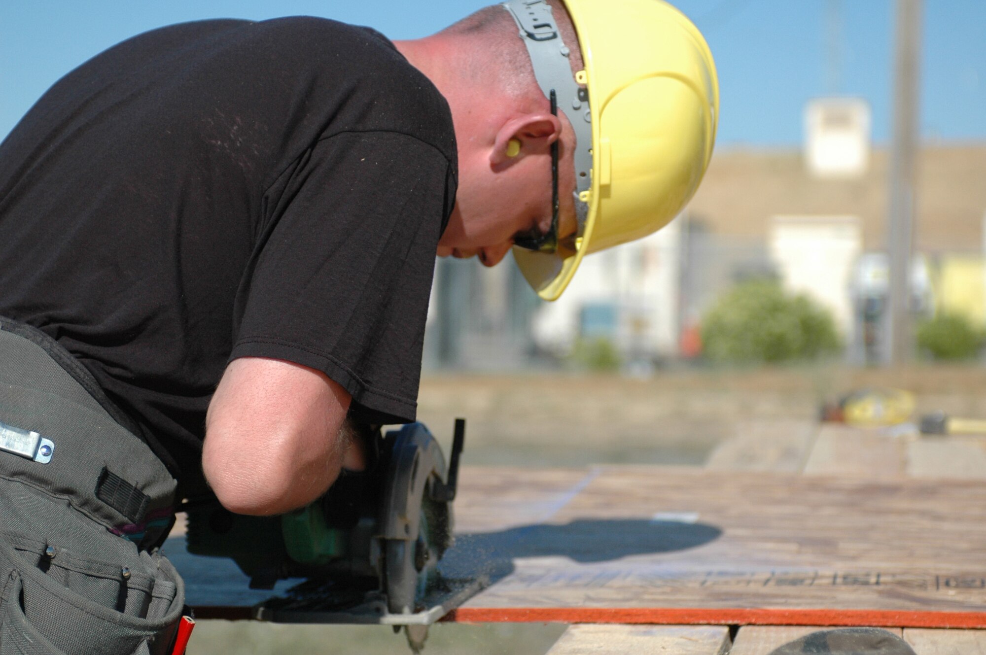 Tech Sgt. Steven Ousley, 60th Civil Engineering Squadron utilities craftsman, cuts plywood bound for the roof of a new building being constructed behind the CE Readiness building here, June 4. The new facilities will be used for a variety of training. (U.S. Air Force photo/Senior Airman Shaun Emery)
 
