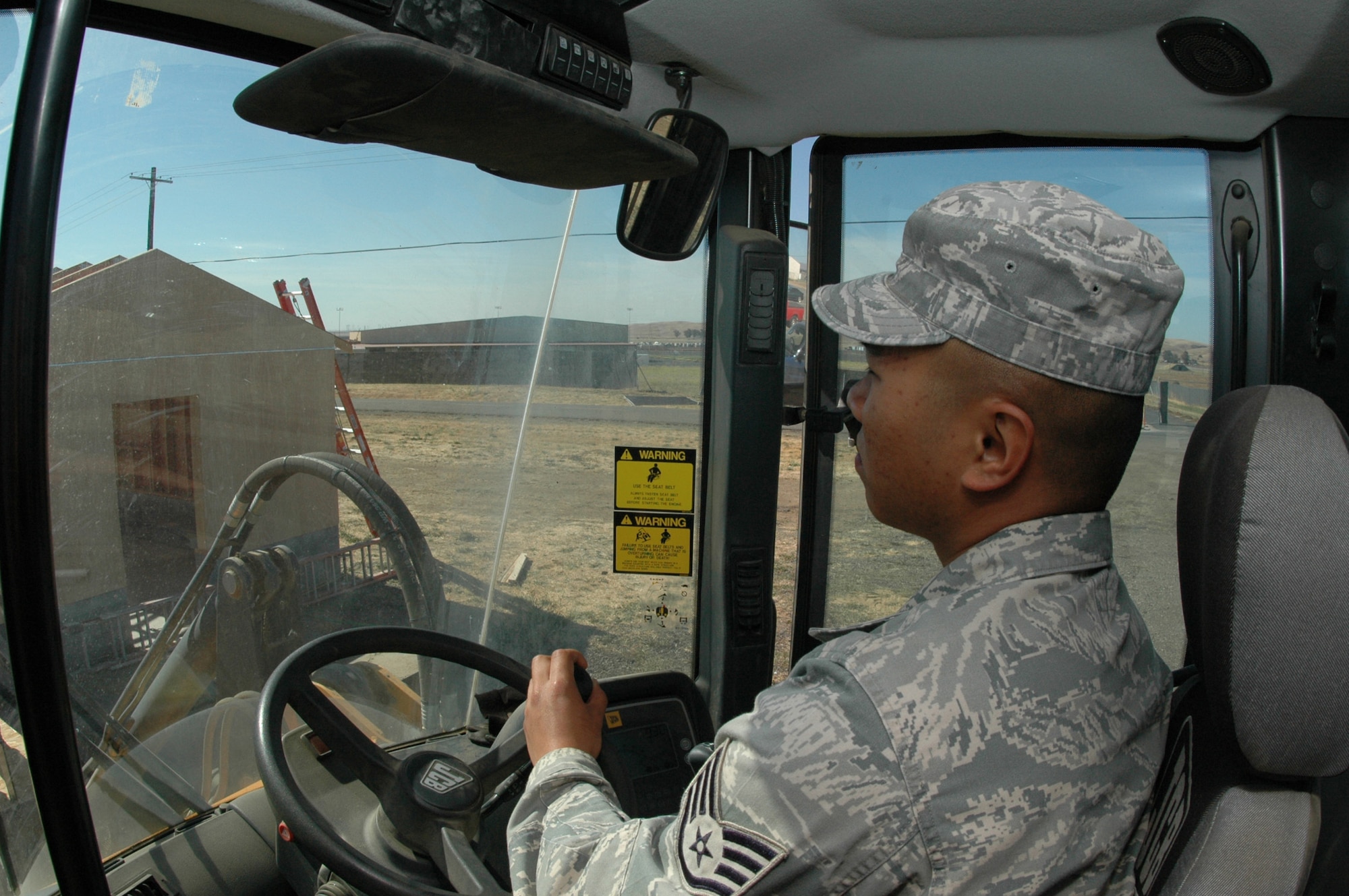 Staff Sgt. Rene Macapagal, 60th Civil Engineering Squadron heavy equipment operator, operates a front-end loader during readiness training, June 4. (U.S. Air Force photo/Senior Airman Shaun Emery)
 
