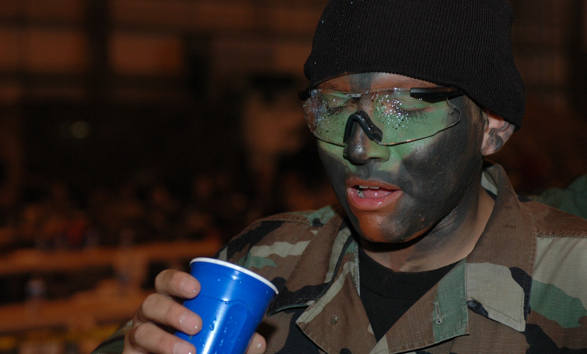 Upon completion of the obstacle course, members of the mess must salute the president of the mess, Chief Master Sgt Michael Williams, 60th Air Mobility Wing command chief, before drinking out of the grog bowl. The grog is a concoction made up of donated items from squadrons around base. (U.S. Air Force photo/Senior Airman Shaun Emery)