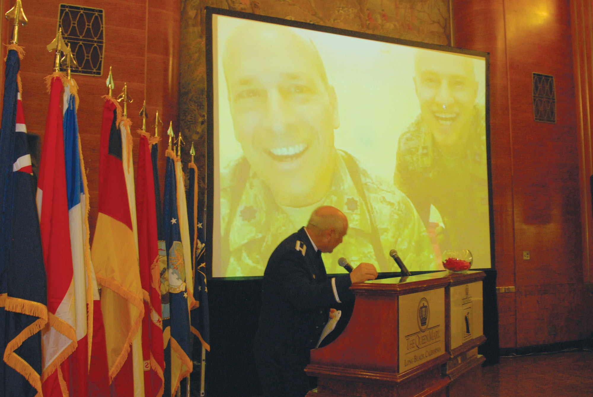 Col Dave Madden, GPS Commander speaks to deployed members, Lt. Col. Anthony Leppellere and Capt. Mark Santasiero at the Wing's Dining Out. (photo by Joe Juarez)