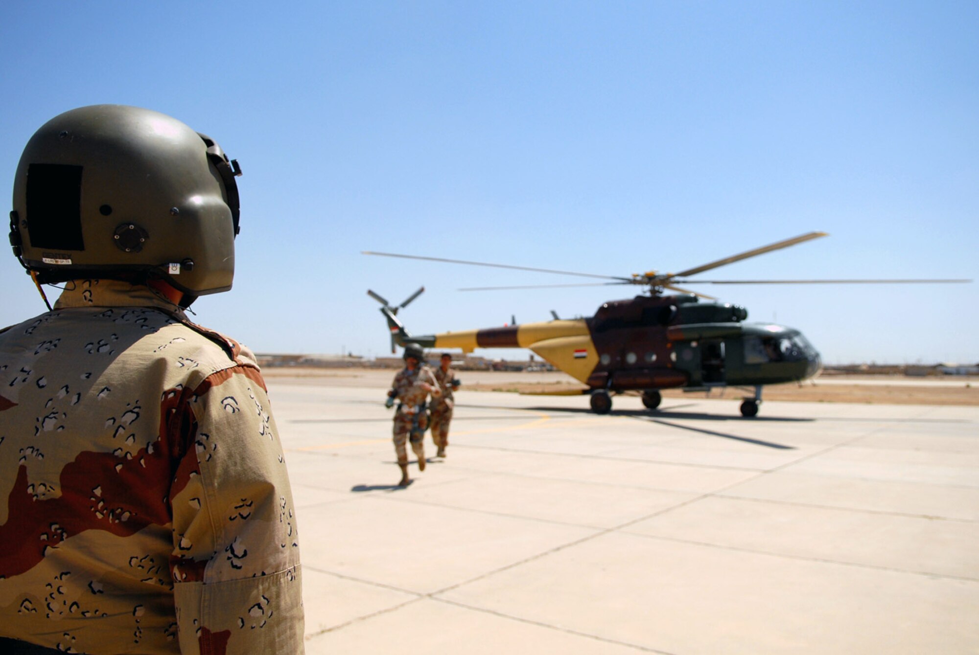 Iraqi air force aerial gunner trainees exit an Mi-17 multirole helicopter after a training mission May 29 at Camp Taji, Iraq. The six-week aerial gunner training course is lead by American Airmen with the 770th Air Expeditionary Advisory Squadron. (U.S. Air Force photo/Senior Airman Julianne Showalter) 
