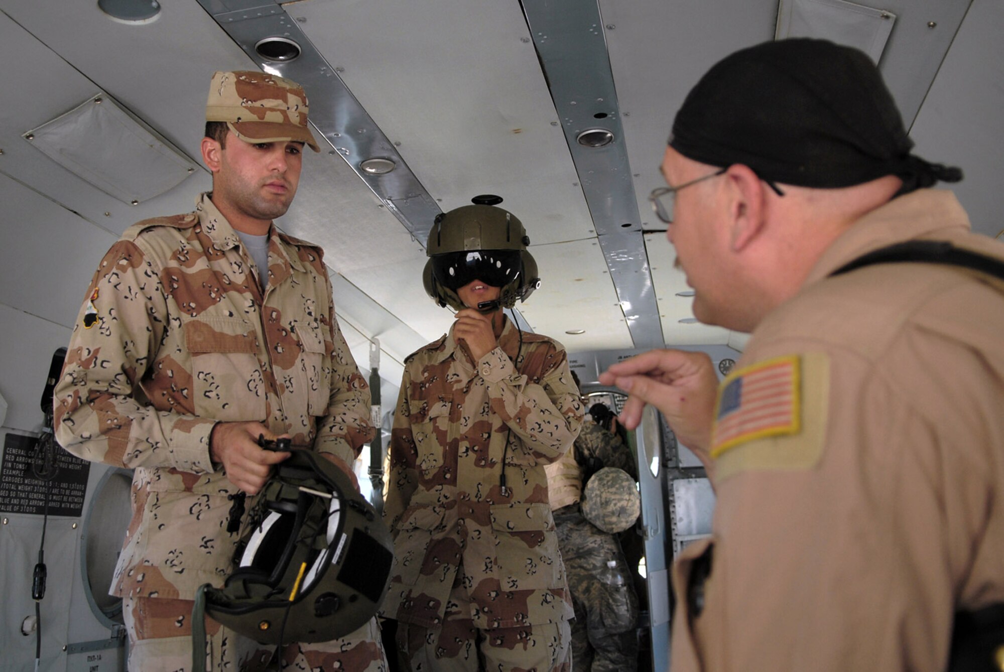 Master Sgt. Bradley Martens gives last-minute instructions to Iraqi air force aerial gunner trainees before a mission May 29 over Camp Taji, Iraq. Sergeant Martens is the 770th Air Expeditionary Advisory Squadron lead aerial gunner training instructor deployed from Hurlburt Field, Fla. (U.S. Air Force photo/Senior Airman Julianne Showalter) 

