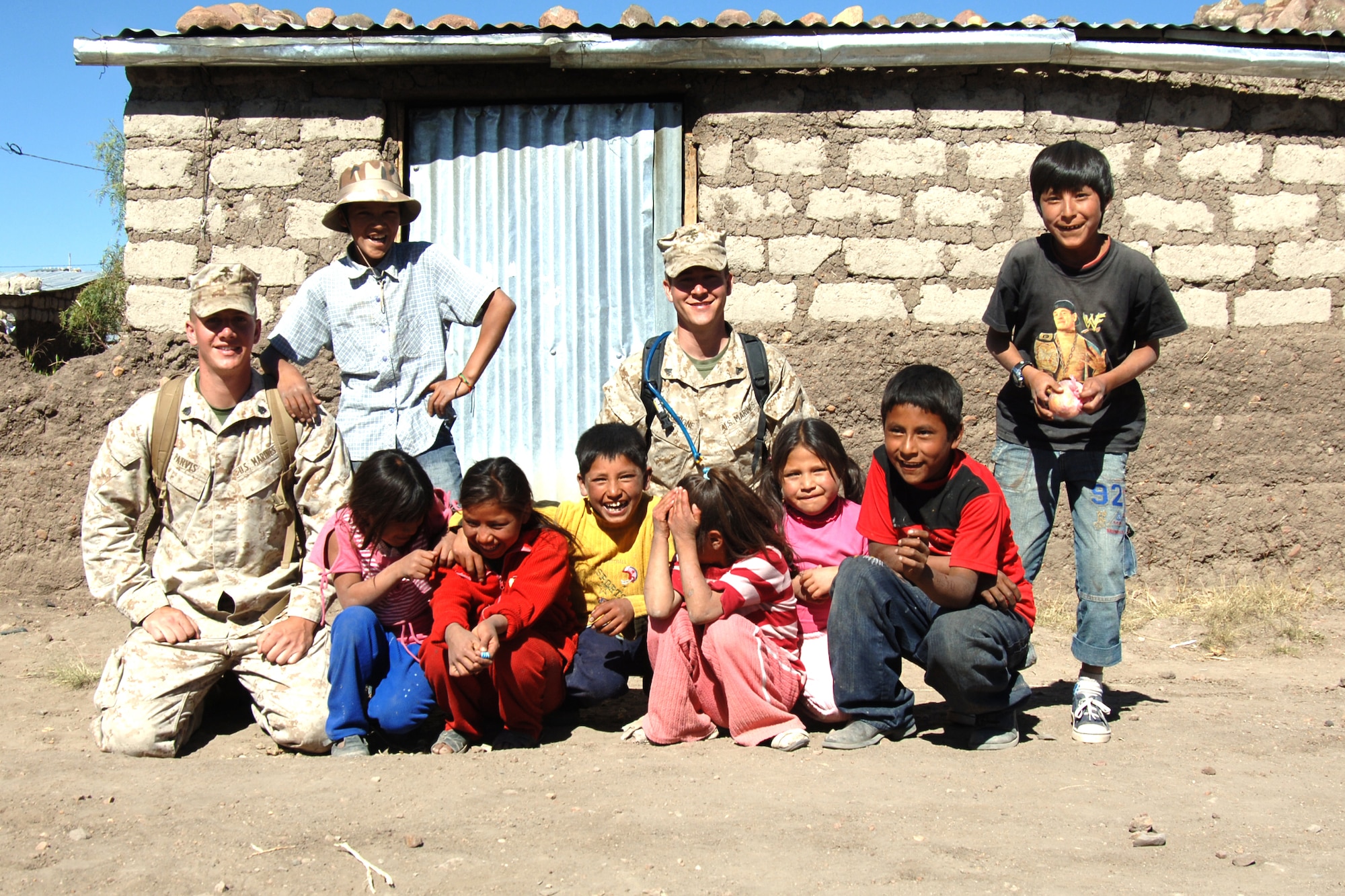 U.S. Marines pose with Peruvian children, June 7, during their visit to Yanama, Peru. U.S. servicemembers are in Peru participating in New Horizons-Peru 2008, a U.S. Southern Command-sponsored humanitarian set on improving the lives of underprivileged Peruvians.  