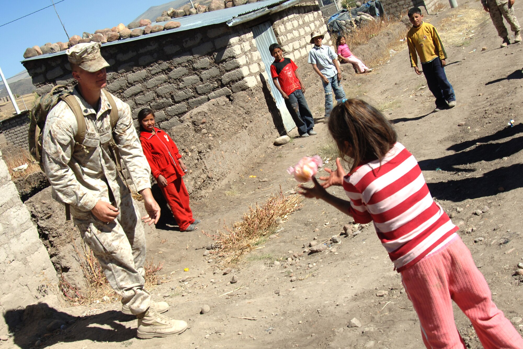 U.S. Marine Sgt. Allan Parvis, plays a game of catch, June 7, with five Peruvian children during a visit to Yanama, Peru. U.S. servicemembers are in Peru participating in New Horizons-Peru 2008, a U.S. Southern Command-sponsored humanitarian set on improving the lives of underprivileged Peruvians. 
