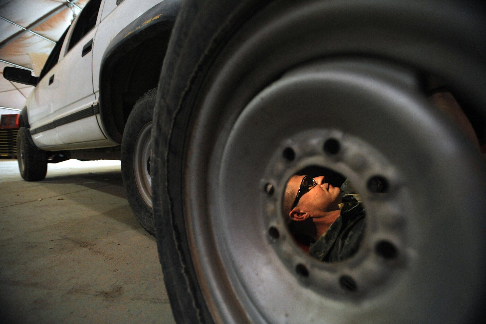 ALI BASE, Iraq -- Staff Sgt. Johnnie Clevenger changes the fuel pump on a sports utility vehicle June 9. He's a vehicle maintainer assigned to the 407th Vehicle Maintenance shop, which is responsible for maintaining the fleet of Air Force vehicles here. The shop also helps maintain vehicles from the U.S. Army, Navy and Romanian military. Sergeant Clevenger is deployed from Holloman AFB, N.M. (U.S. Air Force photo / Staff Sgt. Nathan Gallahan)