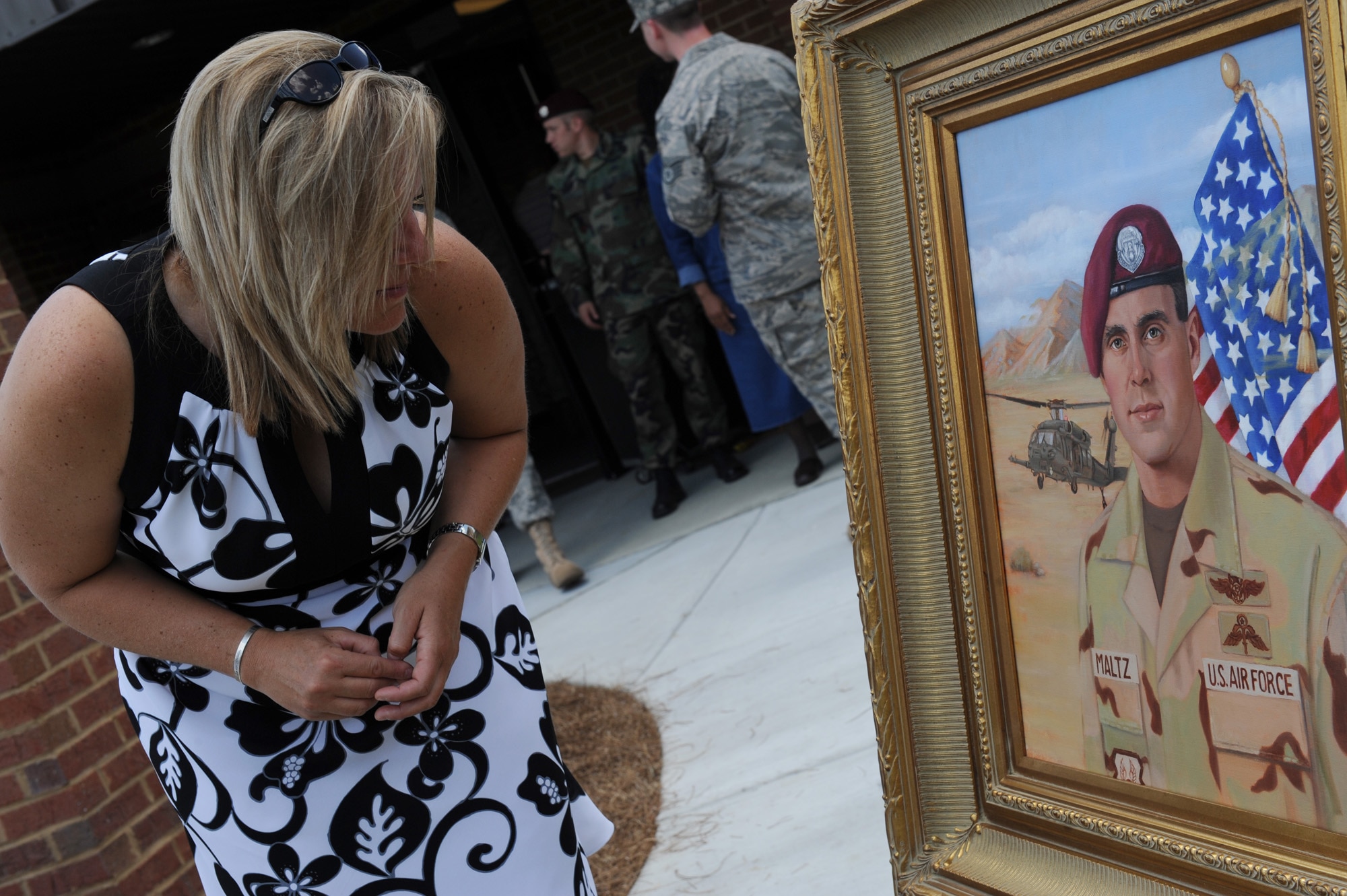 MOODY AIR FORCE BASE, Ga. -- Beverly (Maltz) Chabot, former wife of Master Sgt. Michael Maltz, looks at a painting of sergeant Maltz after a dedication ceremony here June 6. Moody's new First Term Airmen Center was dedicated to fallen pararescueman sergeant Michael H. Maltz, who passed in a helicopter accident during a rescue mission in Afghanistan. (U.S. Air Force photo by Senior Airman Gina Chiaverotti)
