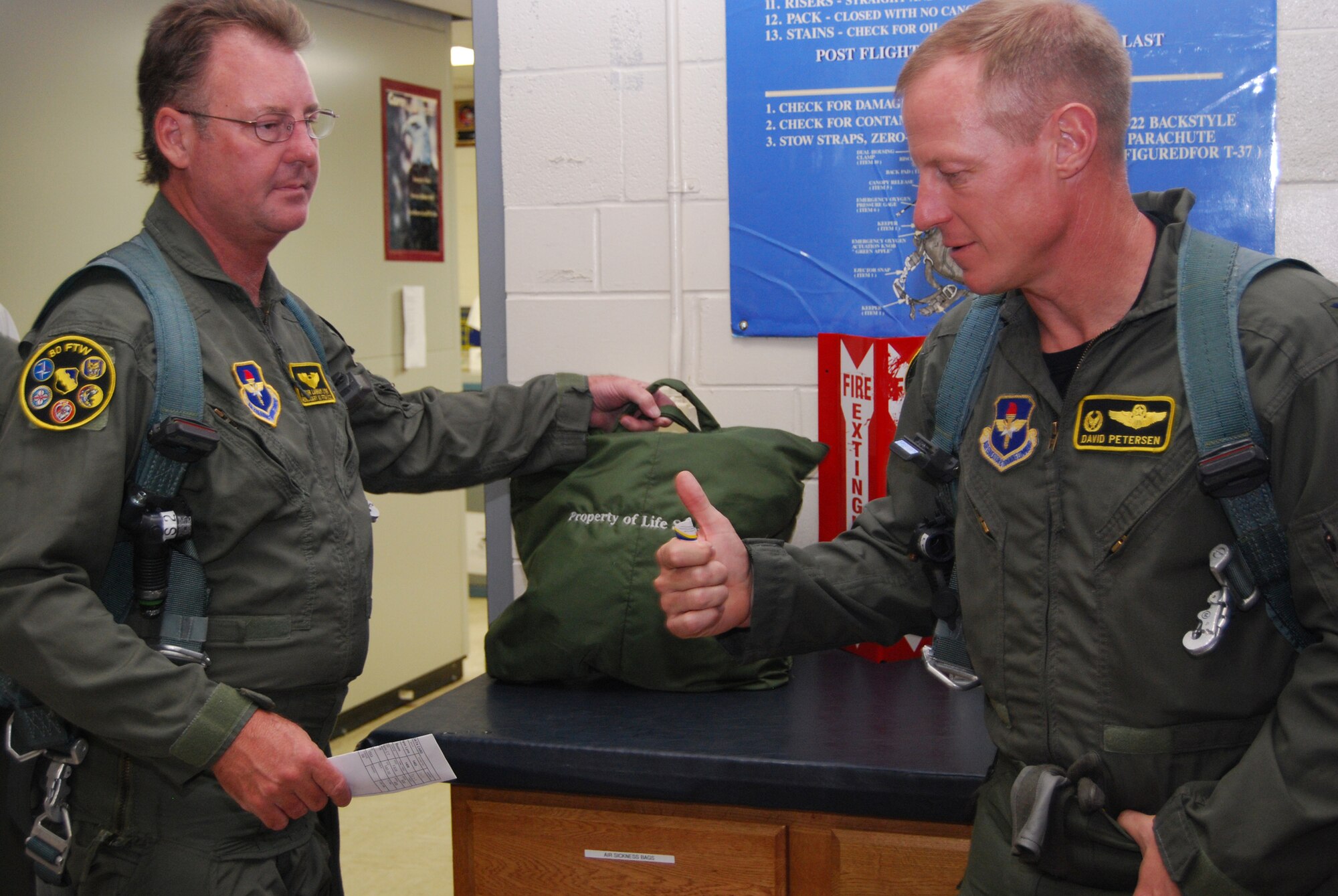 Col. David Petersen, right, gives Lanham Lyne, the 80th Flying Training Wing's honorary commander, preflight instructions prior to a flight June 4. The orientation flight provided Mr. Lyne and inside look at the training conducted by the wing on a daily basis. (U.S. Air Force photo/John Ingle)