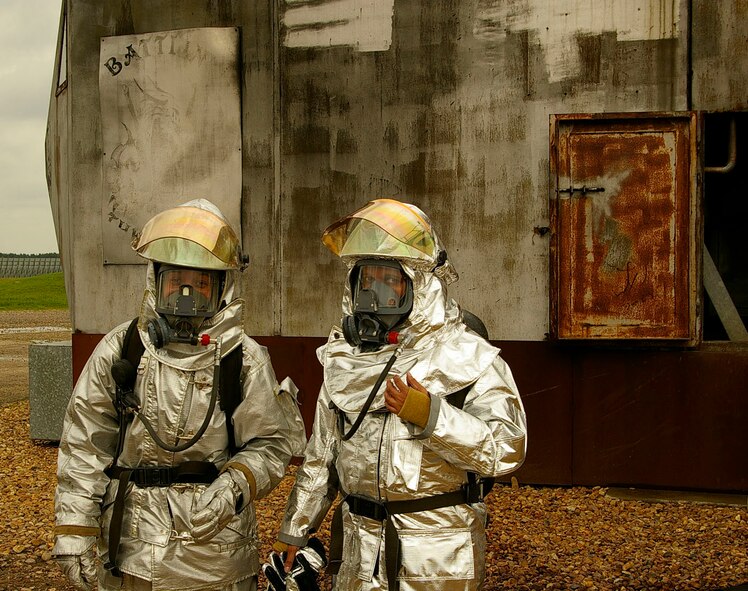 Senior Airman Teresa Hawkins, left, and Karen Abeyasekere, both 100th ARW Public Affairs, right before they went inside the mock aircraft for live fire training with the firefighters. (U.S. Air Force photo by Master Sgt. Rick Henderson)
