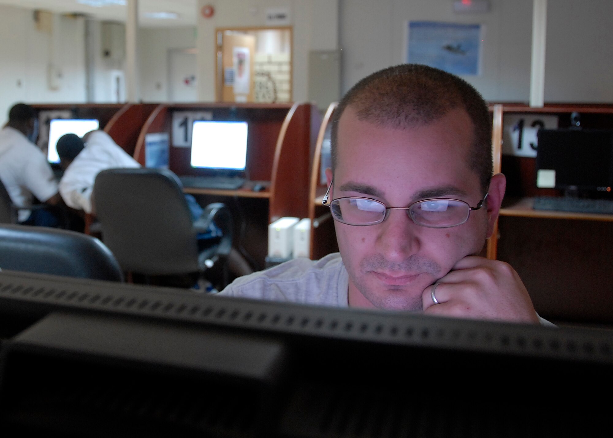 SOUTHWEST ASIA – Staff Sgt. Brian DeRosa, a C-17 Globemaster III loadmaster with the 817th Expeditionary Airlift Squadron, checks his personal e-mail account on-line for a message from home June 6, 2008 at the Oasis morale center on an air base in the Persian Gulf Region. This is Sergeant DeRosa’s first deployment since his 17-month-old son was born and is deployed from Travis Air Force Base, Calif. (U.S. Air Force photo/Tech. Sgt. Michael O’Connor)