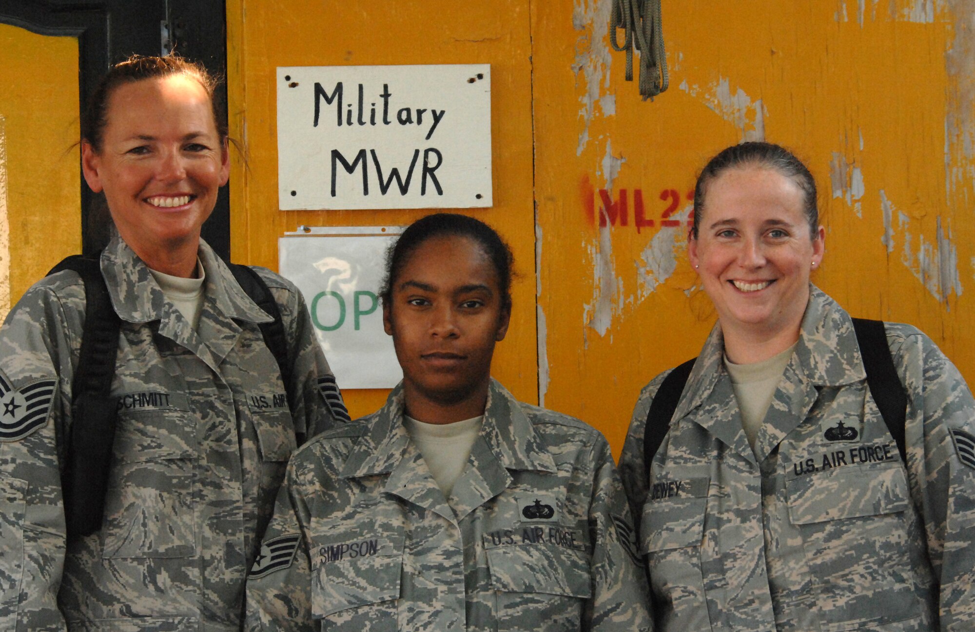 LAGHMAN PROVINCE, Afghanistan – Tech. Sgt. Diane Schmitt, Staff Sgt. Beverly Simpson and Staff Sgt. Laura Dewey (from left to right), Laghman PRT MWR, stand outside the morale, welfare and recreation building here.  The three Airmen have continuously worked on improving both the building and the events and activities. (U.S. Air Force photo br Master Sgt. James Law)