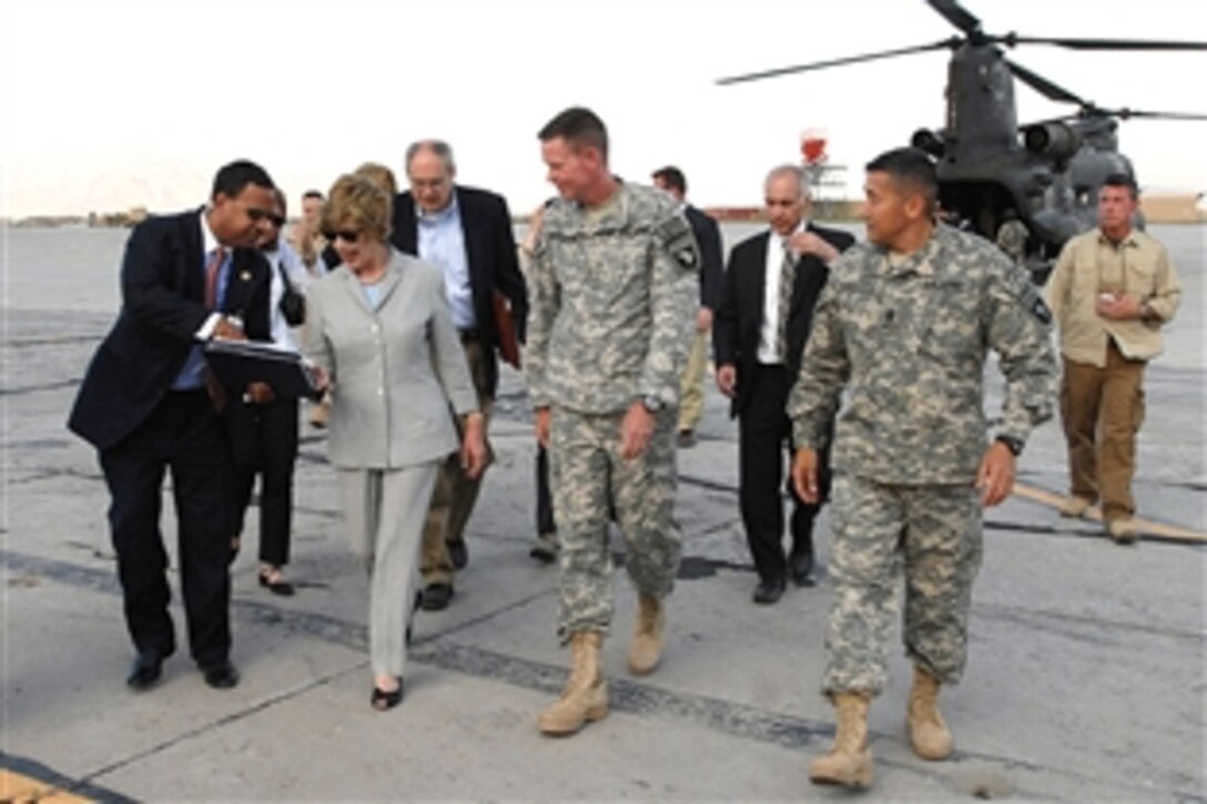 First lady Laura Bush is greeted by U.S. Army Maj. Gen. Jeffrey Schloesser, center, the Combined Joint Task Force-101 commanding general, and Command Sgt. Maj. Vincent Camacho, right, the command sergeant major, just after landing at Bagram Air Field, Afghanistan, June 8, 2008.