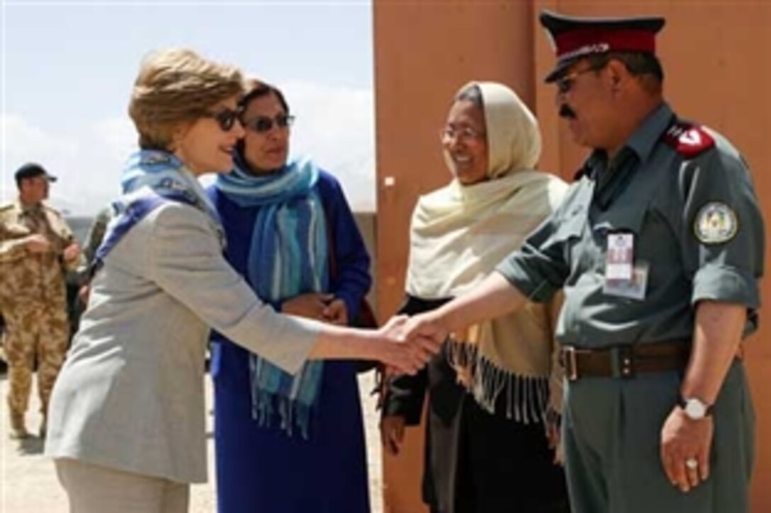 Bamiyan Province Gov. Habiba Sarabi, center, introduces first lady Laura Bush to Col. Hafizullah Paymon, commander of the Afghan Regional Training Center, during a visit to the Police Training Academy in Bamiyan, Afghanistan, June 8, 2008.  
