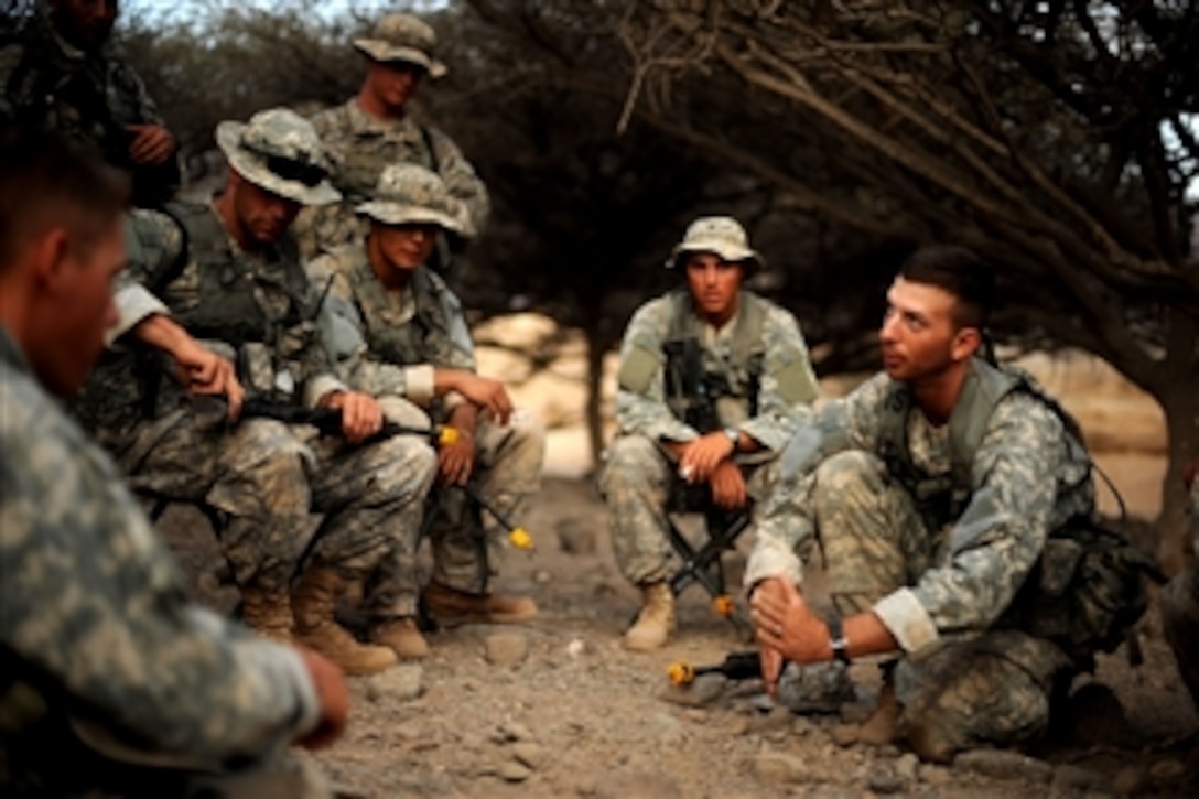 U.S. Army Staff Sgt. Matthew Tardio (right) assigned to 1st Battalion, 3rd U.S. Infantry Regiment briefs his squad on tactical movements before his team runs through a practice drill during a 10-day French Tactical Desert Survival Training Course while deployed with Combined Joint Task Force- Horn of Africa, at Camp Lemonier, Djibouti, on May 7, 2008.  
