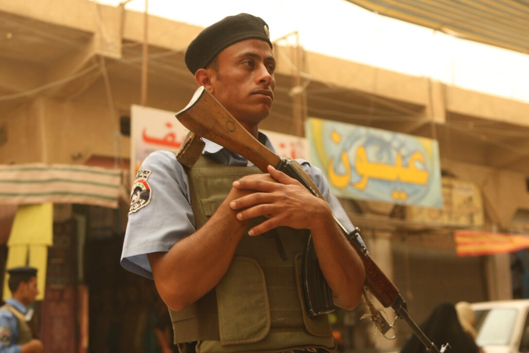 An Iraqi policeman stands security in the marketplace in downtown Ramadi June 9. The surge of 30,000 U.S. troops to Iraq allowed Marines with 1st Battalion, 9th Marine Regiment to focus a great deal on training the Iraqi Security Forces. Now more than a month into their own deployment, Weapons Company, 2nd Battalion, 9th Marine Regiment, Regimental Combat Team 1, has been successful at picking up where their predecessors with 1st Battalion, 9th Marine Regiment, left off.