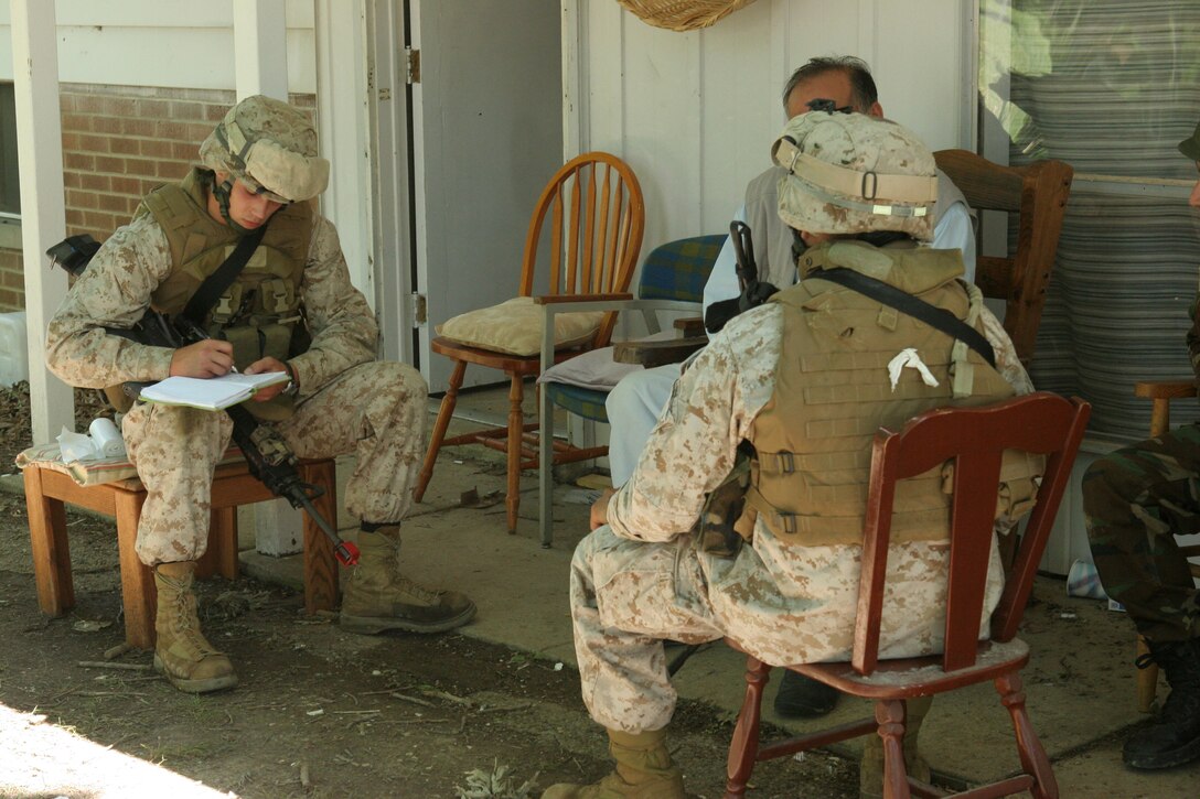 Marines from Battalion Landing Team 2/6, 26th Marine Expeditionary Unit, talk to a role-player acting as a tribal elder during an exercise, June 10, 2008, at Muscatatuck Urban Training Center in Butlerville, Ind.  The Marines were participating in the Realistic Urban Training exercise, and were training to interact with local nationals in stressful situations in an urban environment.  (Official USMC photo by Cpl. Aaron J. Rock)  (Released)::r::::n::