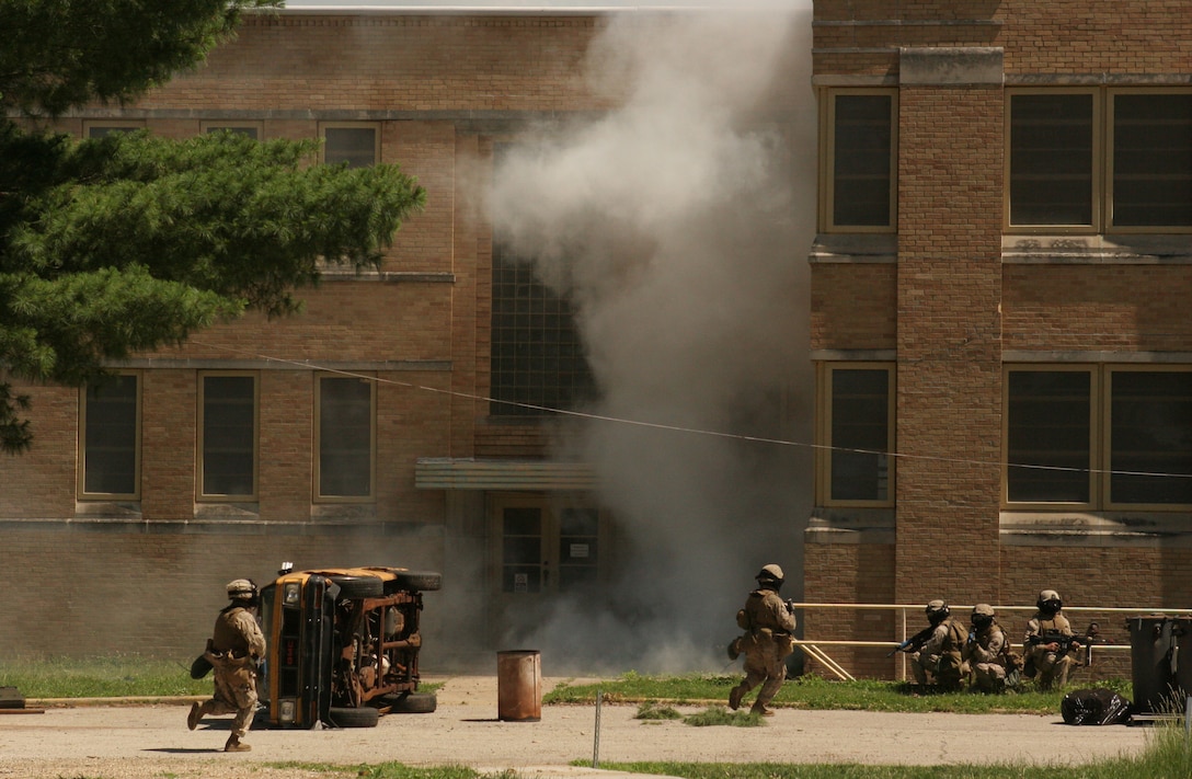 Marines from Battalion Landing Team 2/6, 26th Marine Expeditionary Unit, move between buildings during training, June 10, 2008, at Muscatatuck Urban Training Center in Butlerville, Ind.  The Marines were using the facility during the 26th MEU's Realistic Urban Training exercise, part of the MEU's predeployment training period.  (Official USMC photo by Cpl. Aaron J. Rock) (Released)
