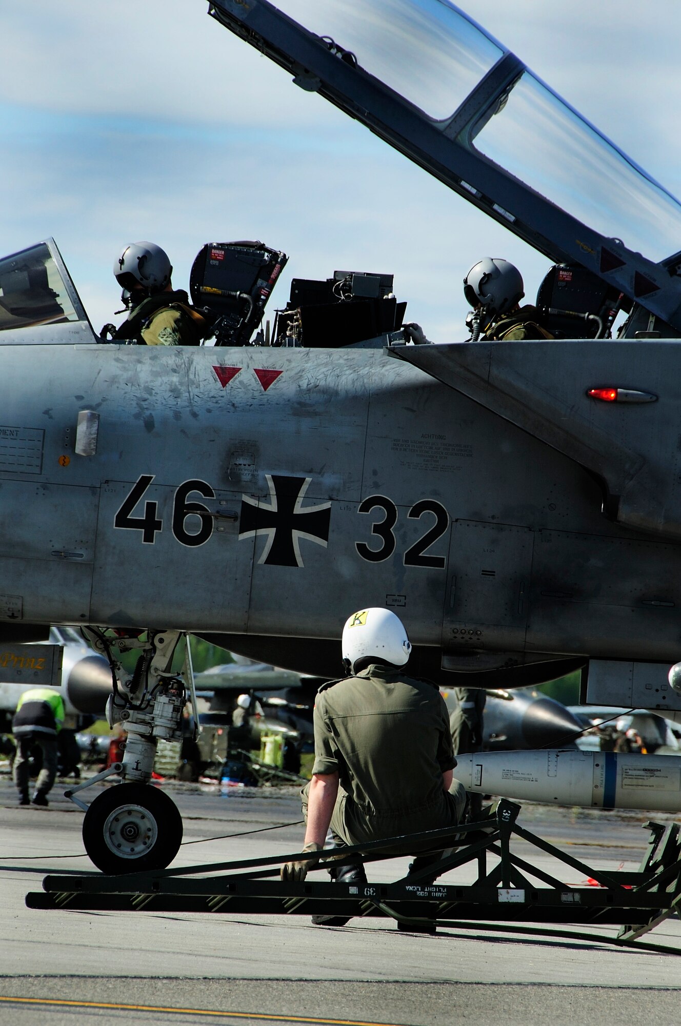 EIELSON AIR FORCE BASE, Alaska --Two German Air Force pilots go through a pre-flight inspection, while their
crew chief sits waiting further instruction June 9, 2008 at Eielson AFB, Alaska. The Germans are participating in RED FLAG-Alaska 08-3, a realistic, 10-day air combat training exercise held up to four times a year taking
place over Alaskan and Western Canadian airspace.  (U.S. Air Force photo by Airman 1st Class Christopher Griffin)