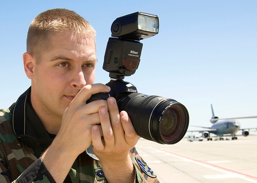 Local Time 11:20   Zulu Time 18:20Senior Airman Shaun Emery, 60th Air Mobility Wing Public Affairs journeyman, arrives at the Travis Air Force Base, Calif. flight line to photograph the departure of a distinguished visitor. Airman Emery goes out into the field weekly to photograph and interview for the weekly base newspaper, "The Tailwind."  USAF photo by Civ/Amanda Lopez 