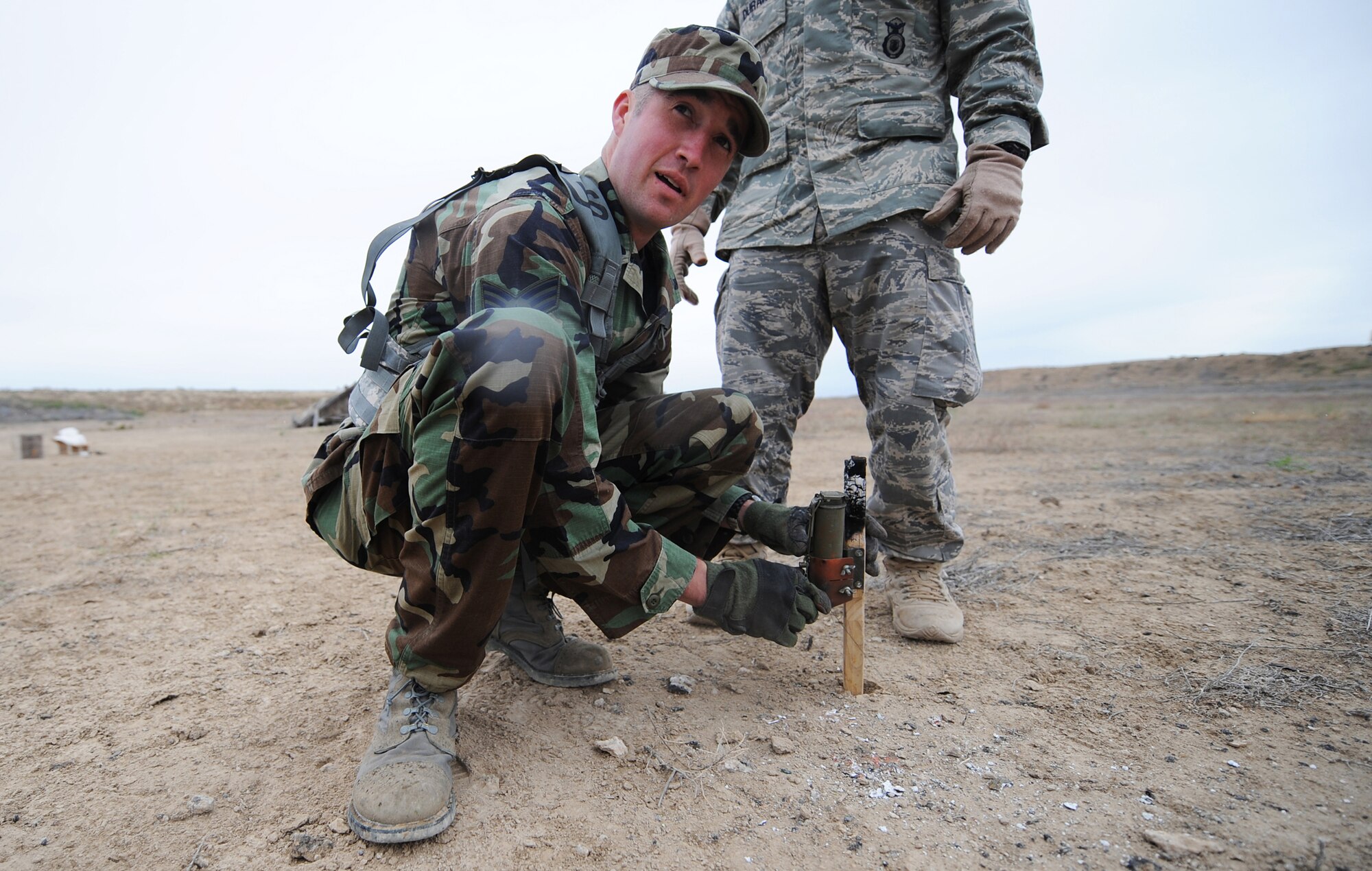MOUNTAIN HOME AIR FORCE BASE, Idaho - Senior Airman Stephen Bratcher, 366th Security Forces Squadron patrolman, attaches wire to a trip flare during a training exercise June 4. Trip flares are used as an early warning system to alert SFS members of an incoming threat. The 366th SFS gives its members hands-on training in scenarios they may run into while in a deployed environment. (U.S. Air Force photo/ Airman 1st Class Ryan Crane)