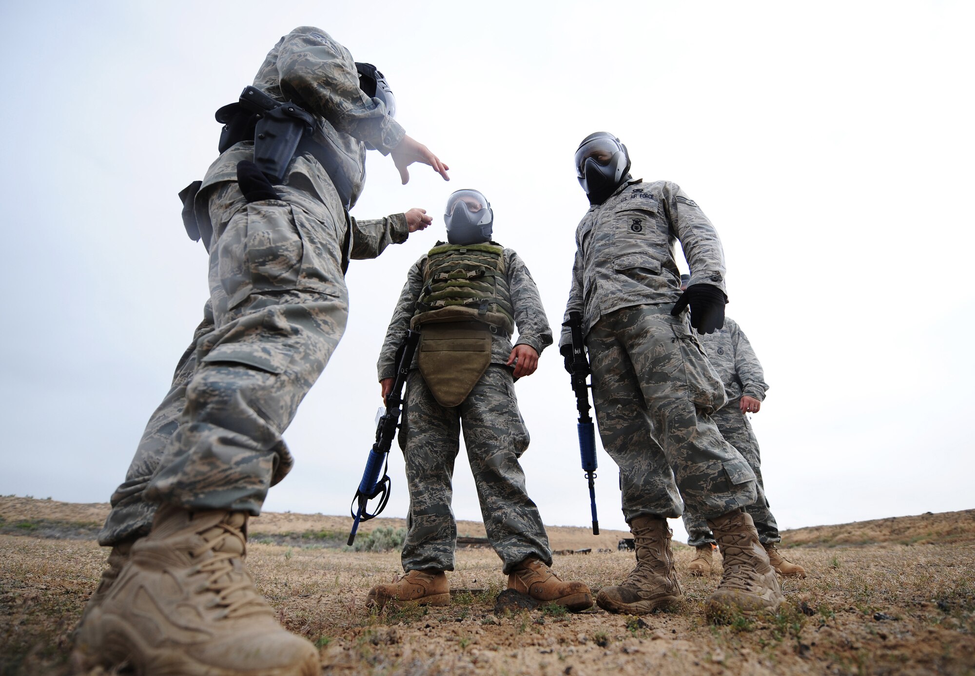 MOUNTAIN HOME AIR FORCE BASE, Idaho - Tech. Sgt. Bobby Singleton, 366th Security Forces Squadron training instructor, explains to Staff Sgt. David Dewey and Senior Airman Marquis Taylor, 366th SFS patrolmen, how to enter a room with suspected hostile forces June 4. The 366th SFS gives its members hands-on training in scenarios they may run into while in a deployed environment. (U.S. Air Force photo/ Airman 1st Class Ryan Crane)