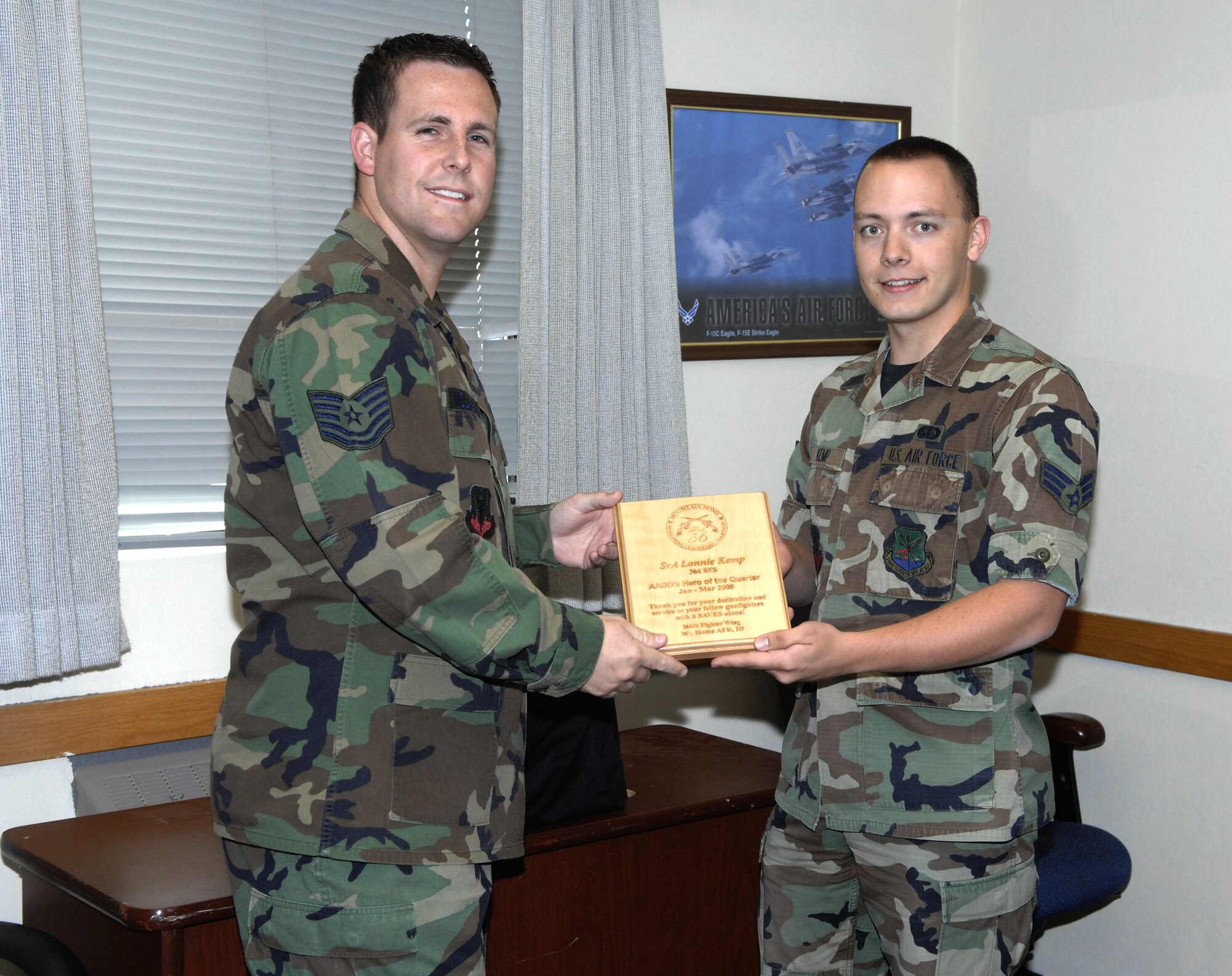 MOUNTAIN HOME AIR FORCE BASE, Idaho - Tech. Sgt. Will McLaughlin, 366th Contracting Squadron and Focus 56 president, presents Senior Airman Lonnie Kemp, 366th Security Forces Squadron, with a plaque from the Mountain Home Focus 56 after being named the Airman Against Drunk Driving’s Hero of the Quarter June 6 at the 366th SFS headquarters building. Airman Kemp had eight saves from January to March. (U.S. Air Force photo/ Staff Sgt. Brian Stives)
