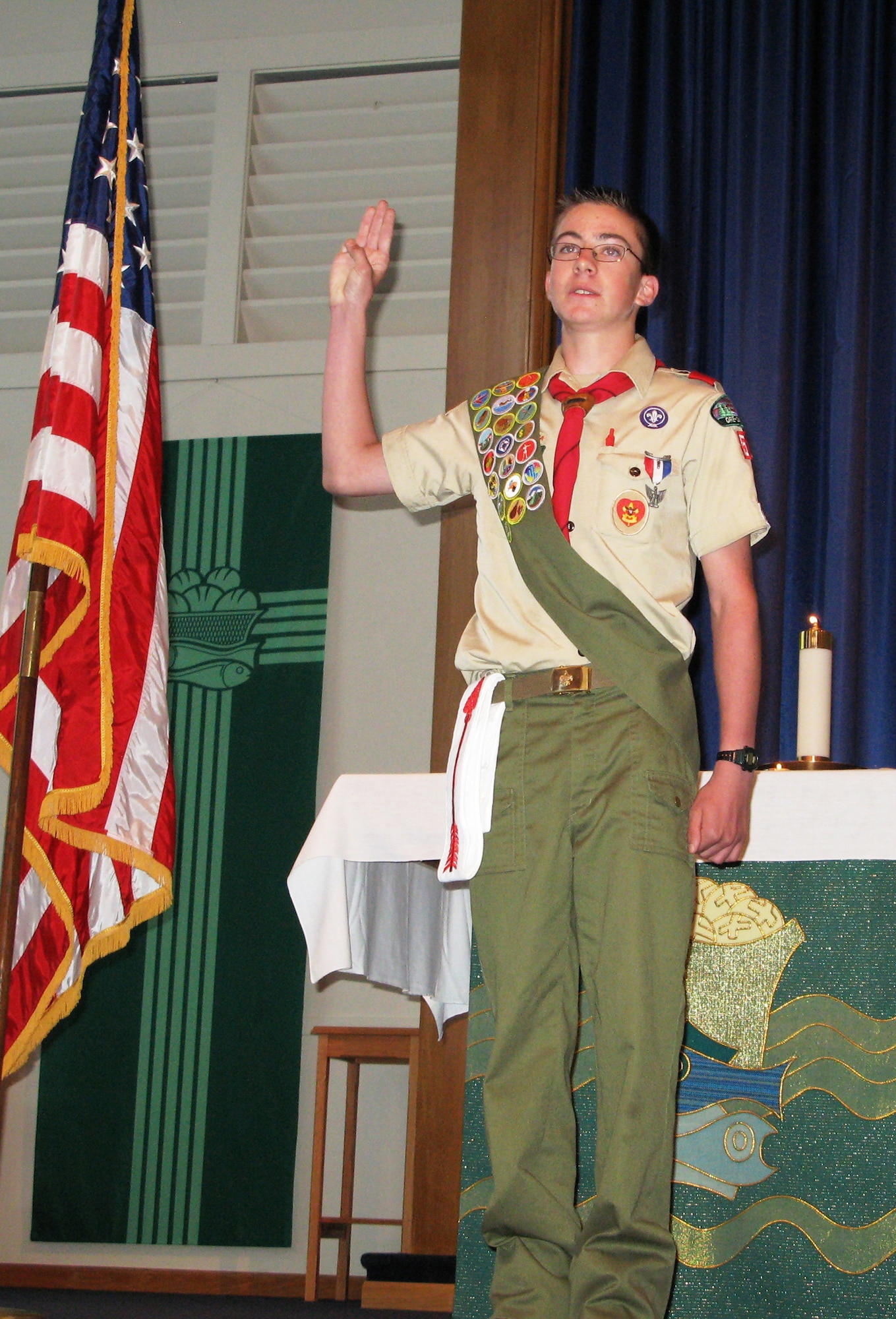 MOUNTAIN HOME AIR FORCE BASE, Idaho - Paul Ritschard, son of Lt. Col. Hans Ritschard, 366th Medical Operations Squadron commander, recites the Boy Scout Oath after being awarded the rank of Eagle Scout at Liberty Chapel June 5. Only three percent of all boys who join scouting attain the rank of Eagle Scout. Part of Paul's road to becoming an Eagle Scout was refurbishing the base golf course sign, a project that included leading a team of 11 Scouts and adults over several weekends. (Courtesy Photo/ Erik Ritschard)