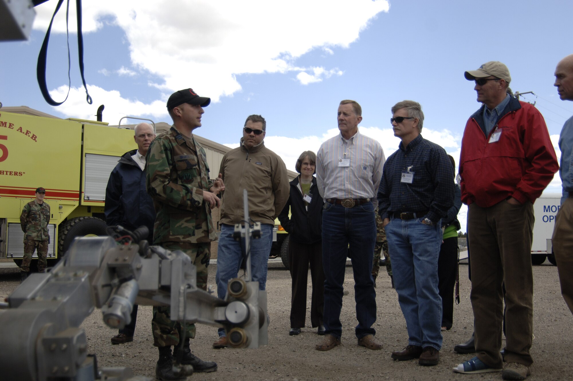 MOUNTAIN HOME AIR FORCE BASE, Idaho - Capt. Allen Branco, 366th Civil Engineer Squadron explosive ordnance disposal flight commander, briefs members of the 366th Fighter Wing honorary commanders program on the use of the F6A, a robot used to handle unknown explosives while Airmen remain at a safe distance, during a tour of the 366th Mission Support Squadron June 6. The honorary commanders program pairs together civic leaders with squadron, group and wing leaders to enhance relationships between local communities and the base. It also provides a rare glimpse of life on a military installation to members of neighboring communities -- many of whom have no connection to the Air Force or prior knowledge of the military. (U.S. Air Force photo/ Staff Sgt. Rodney D. Ivey)