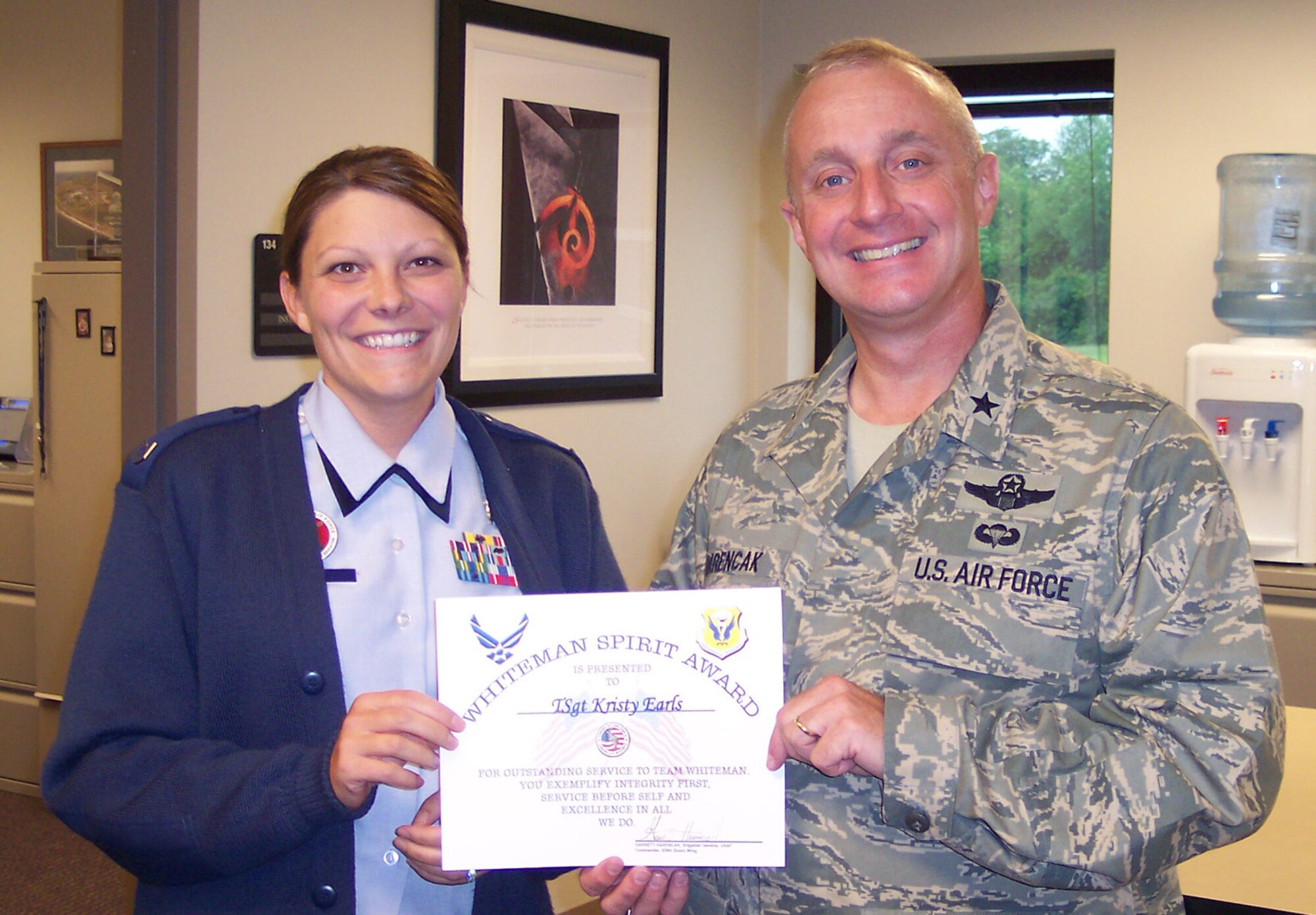 Brig. Gen. Garrett Harencak, 509th Bomb Wing commander, presents Tech. Sgt. Kristy L. Earls, 509th Mission Support Squadron Airman Leadership School instructor, with the Whiteman Spirit Award June 2. (U.S. Air Force courtesy photo)