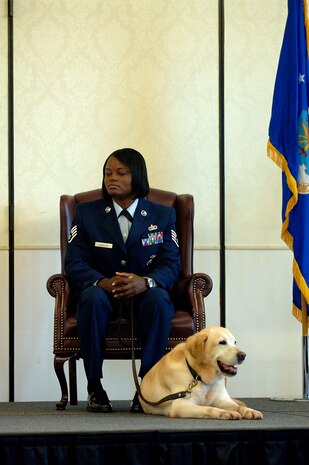 Staff Sgt. Catharine Johnson sits with Liz on stage during Liz's retirement ceremony on Charleston Air Force Base, S.C., June 10, 2008. Sergeant Johnson was Liz's K9 handler and Liz is a military working dog who has served in the 437th Security Forces Squadron for 10 years and has been on a multitude of temporary duty assignments to include Greece, Saudi Arabia and Iraq. She also went on seven different Secret Service and Department of State missions to protect President Bush and President Clinton. (U.S. Air Force photo/Senior Airman Nicholas Pilch)