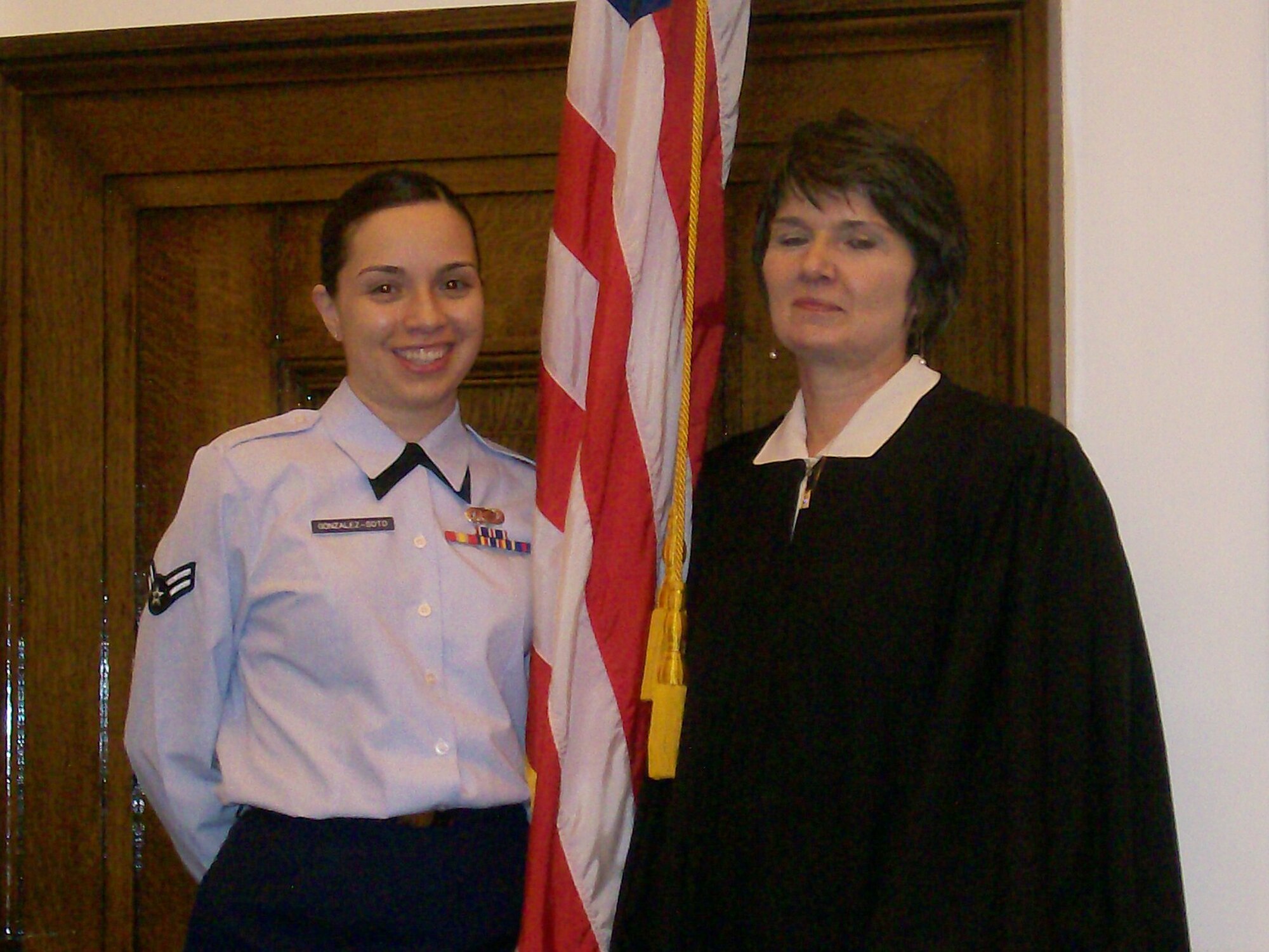 MINOT AIR FORCE BASE, N.D. -- Airman 1st Class Maria Gonzales-Soto, an information manager with the 5th Mission Support Group, stands with the judge who conducted her swearing-in ceremony in Grand Forks, N.D., April 25. The ceremony officially recognized Airman Gonzales-Soto as an American citizen. (Courtesy photo)