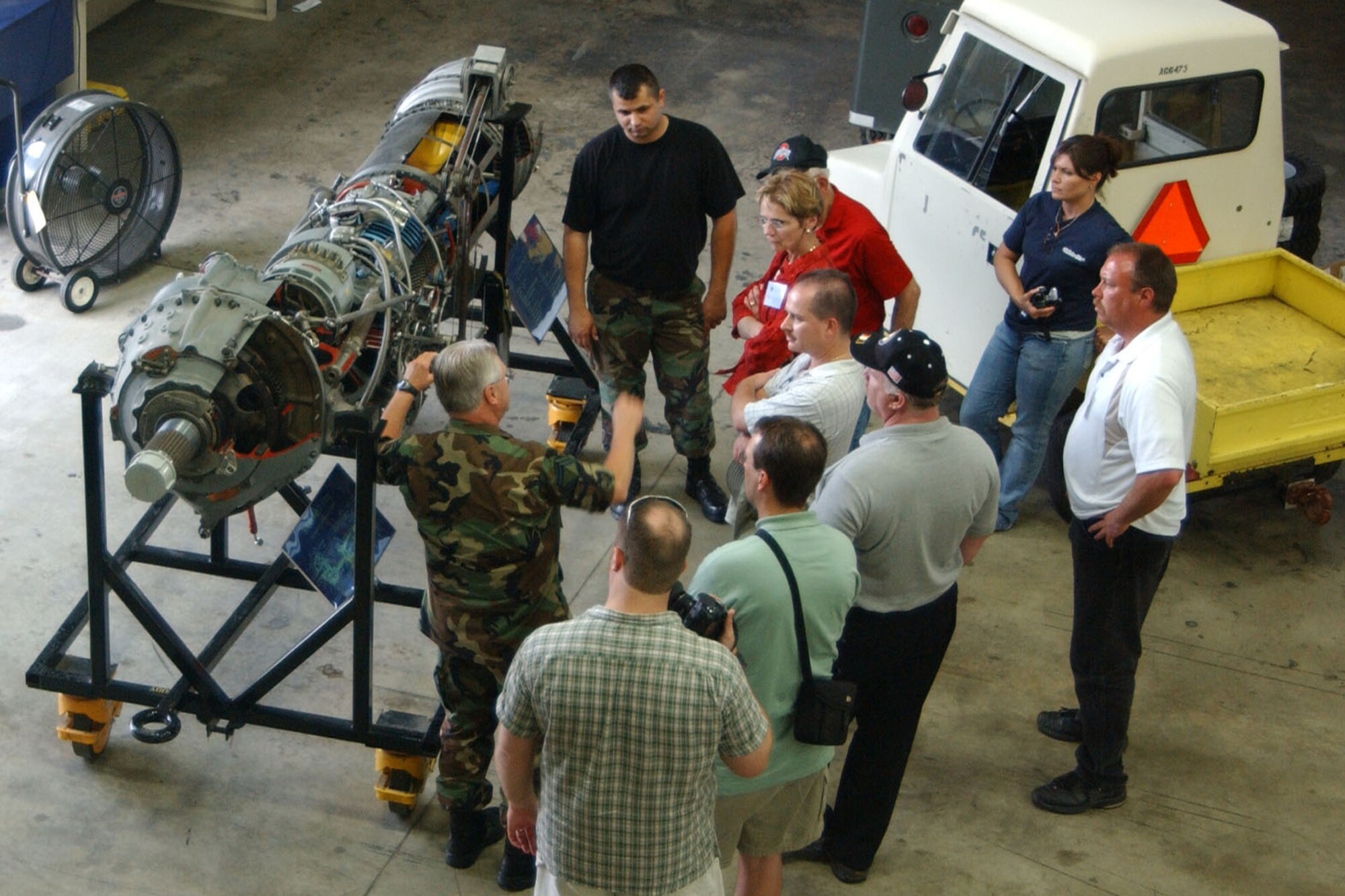 YOUNGSTOWN AIR RESERVE STATION, Ohio -- Air Force Reserve Senior Master Sergeant Joe Hollabaugh, from the 910th Propulsion Shop, talks to civilian employers about the T56 engine for a C-130. U.S Air Force Photo/Senior Airman Clinton E. Kline.        