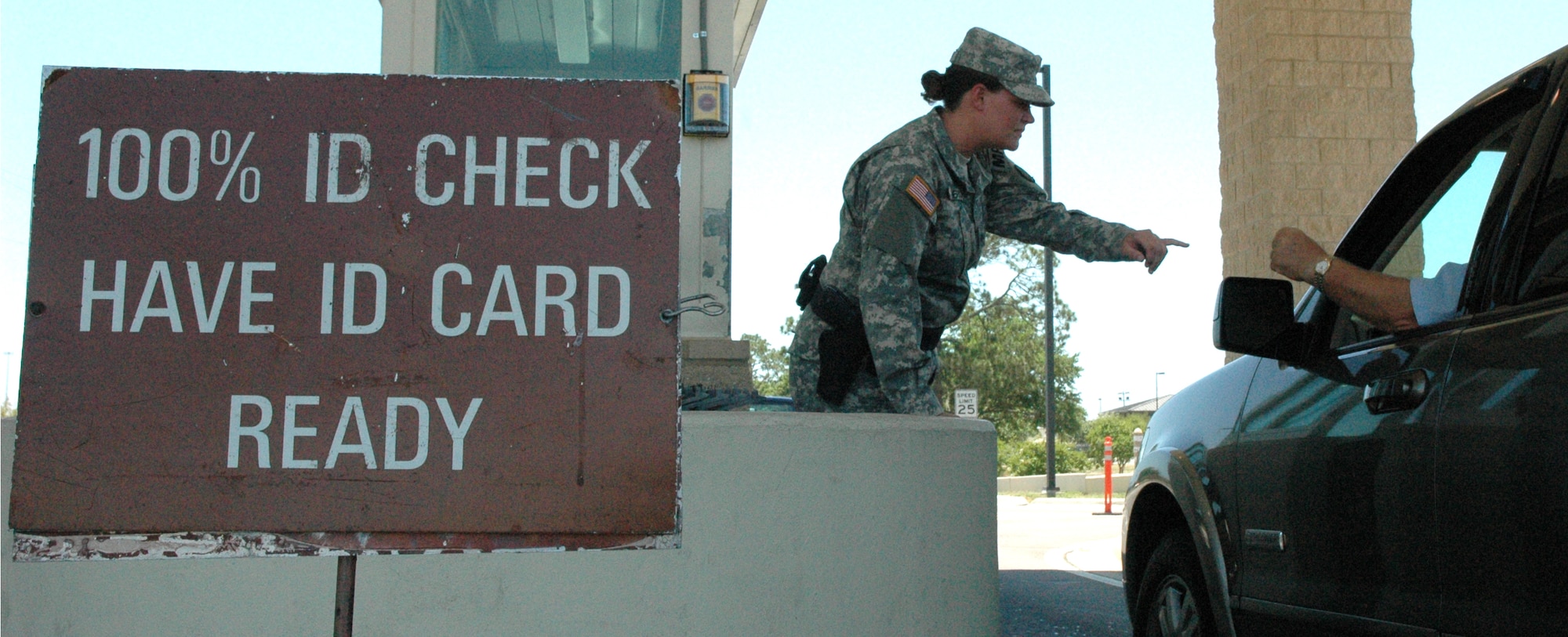 Private 1st Class Jennifer Anderson, 128th Military Police Company from the Alabama Army National Guard, checks the ID cards of incoming traffic entering through the Eglin East Gate June 6. Hailing from Huntsville, Ala., Pfc. Anderson is here to complete annual training.