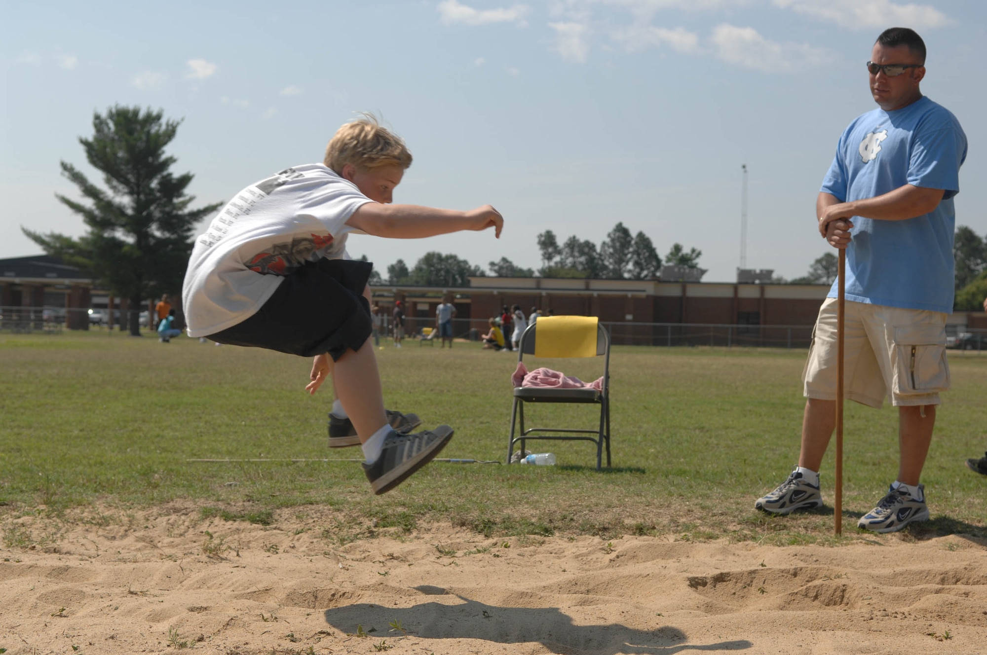 SUMTER, S.C. -- Master Sgt. Kevin Fry, U.S. Air Forces Central, coaches students from Alice Drive Elementary School during a long jump competition June 2. Airmen from U.S. Air Forces Central, located on Shaw Air Force Base, volunteered for the school's "Fun Day" to help students and staff organize the activities. (U.S. Air Force photo/Airman 1st Class Matthew Davis)