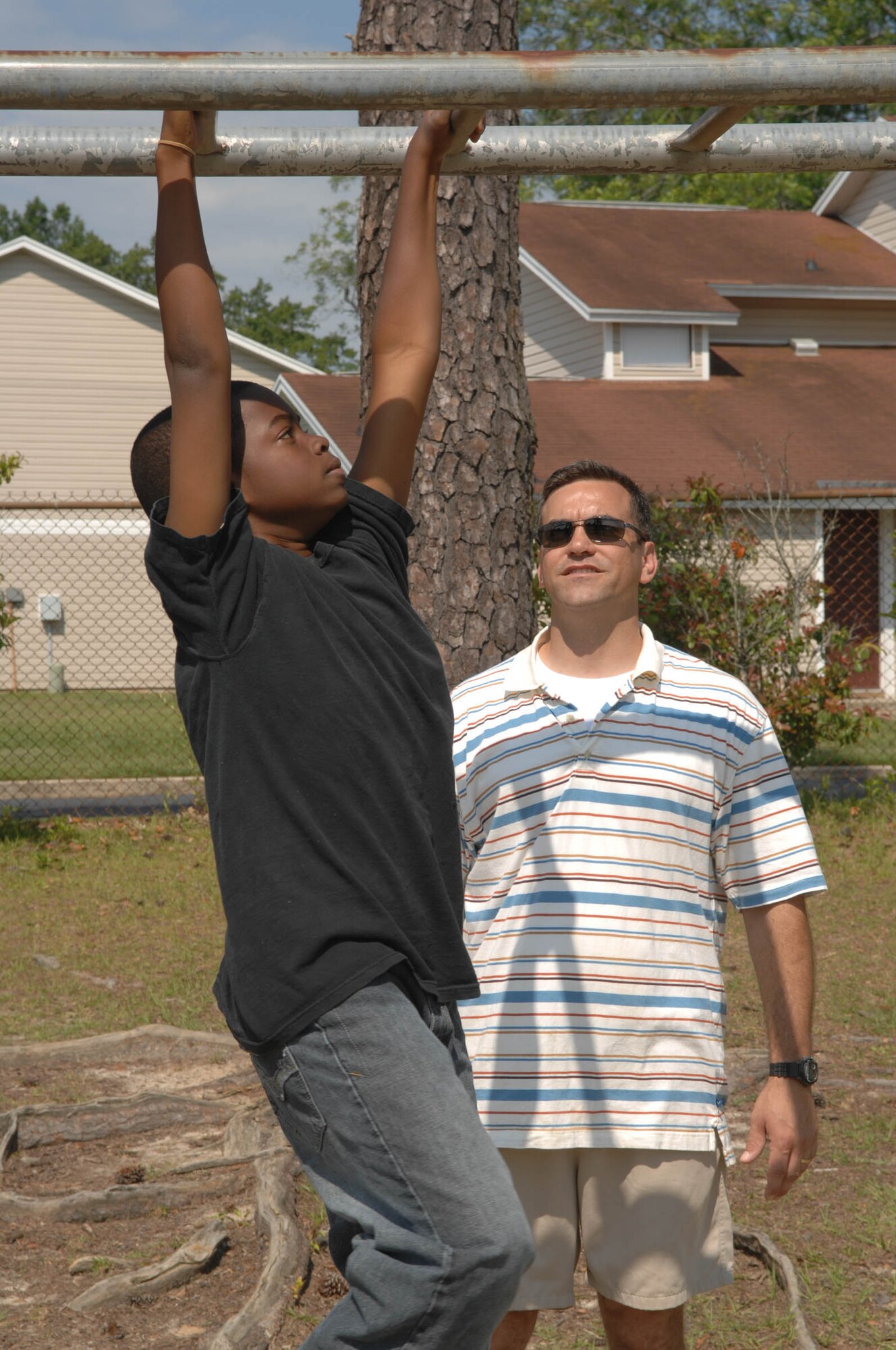 SUMTER, S.C. -- Capt. Douglas House, U.S. Air Forces Central, coaches students from Alice Drive Elementary School during an obstacle course June 2. Airmen from U.S. Air Forces Central, located on Shaw Air Force Base, volunteered for the school's "Fun Day" to help students and staff organize the activities. (U.S. Air Force photo/Airman 1st Class Matthew Davis)