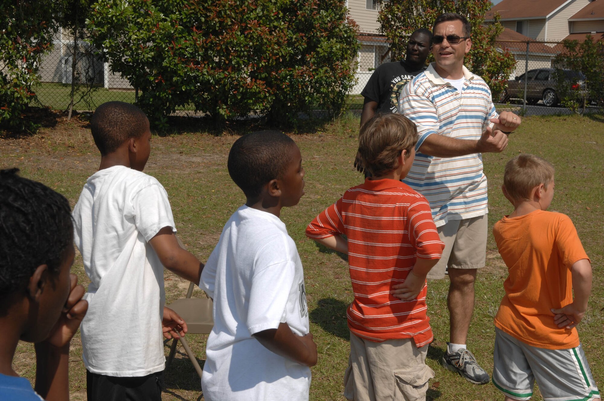 SUMTER, S.C. -- Capt. Douglas House, U.S. Air Forces Central, coaches students from Alice Drive Elementary School during an obstacle course June 2. Airmen from U.S. Air Forces Central, located on Shaw Air Force Base, volunteered for the school's "Fun Day" to help students and staff organize the activities. (U.S. Air Force photo/Airman 1st Class Matthew Davis)