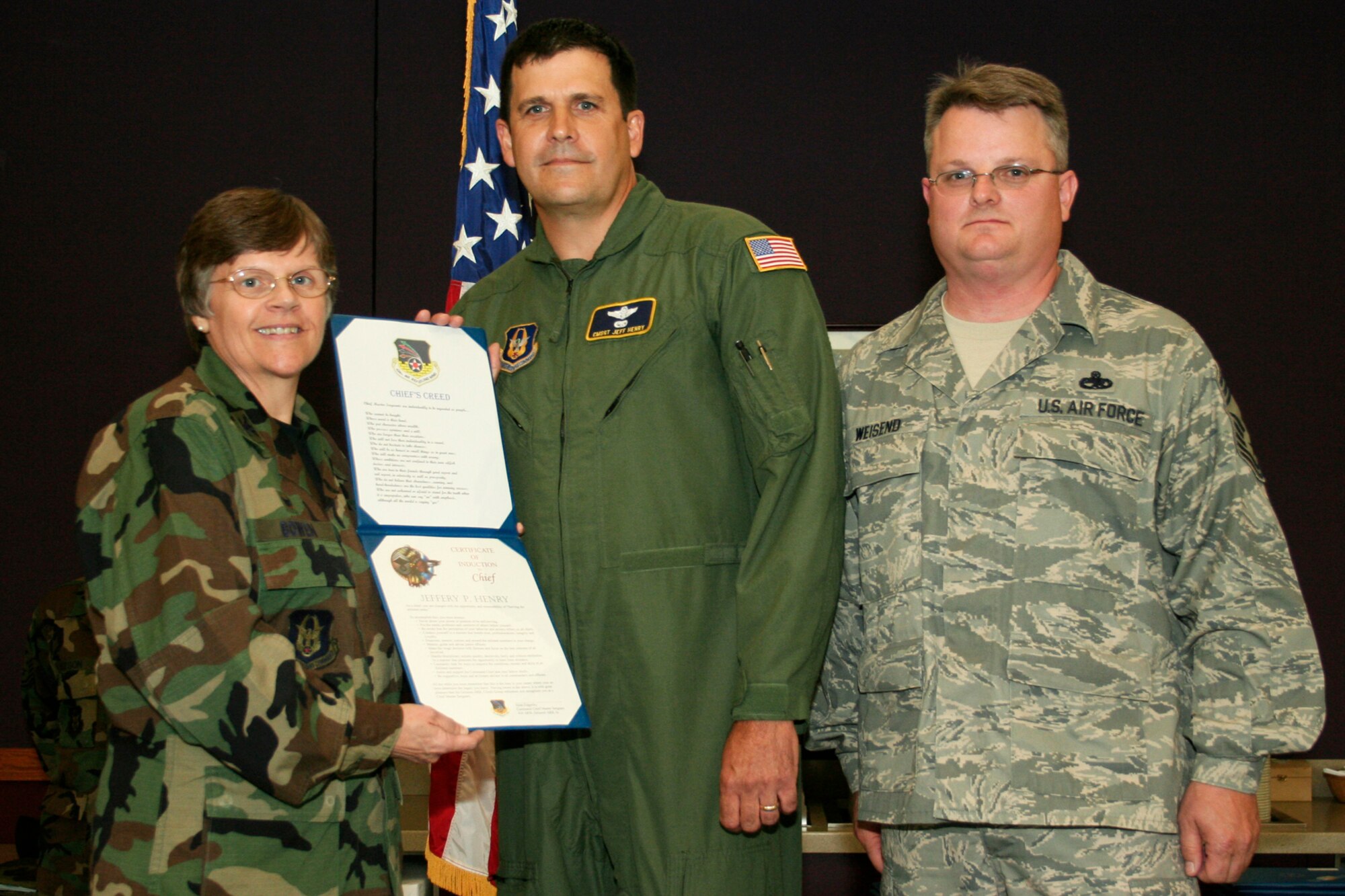 GRISSOM AIR RESERVE BASE, Ind., -- Chief Master Sgt. Jeff Henry, chief boom of the 72nd Air Refueling Squadron, is recognized during the quarterly promotion ceremony by Col. Betty Bowen, 434th Mission Support Group commander, and Chief Master Sgt. Chad Weisend, 434th Maintenance Group superintendent. (U.S. Air Force photo/Tech. Sgt. Patrick Kuminecz)
