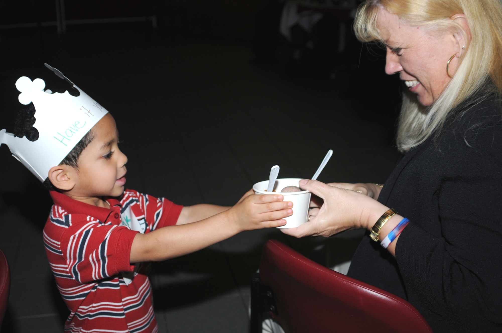 Four-year-old Daylen Walker serves homemade ice cream prepared by boys and girls enrolled at the child development center to Annette Gardner, a child care professional from Travis Air Force Base, Calif.  Ms. Gardner attended the Air Force Worldwide Child Care Conference at Keesler June 4 through Friday.  Daylen’s parents are Staff Sgts. Daylen and Sandra Walker, 81st Supply-Transportation Squadron.  (U.S. Air Force photo by Kemberly Groue)