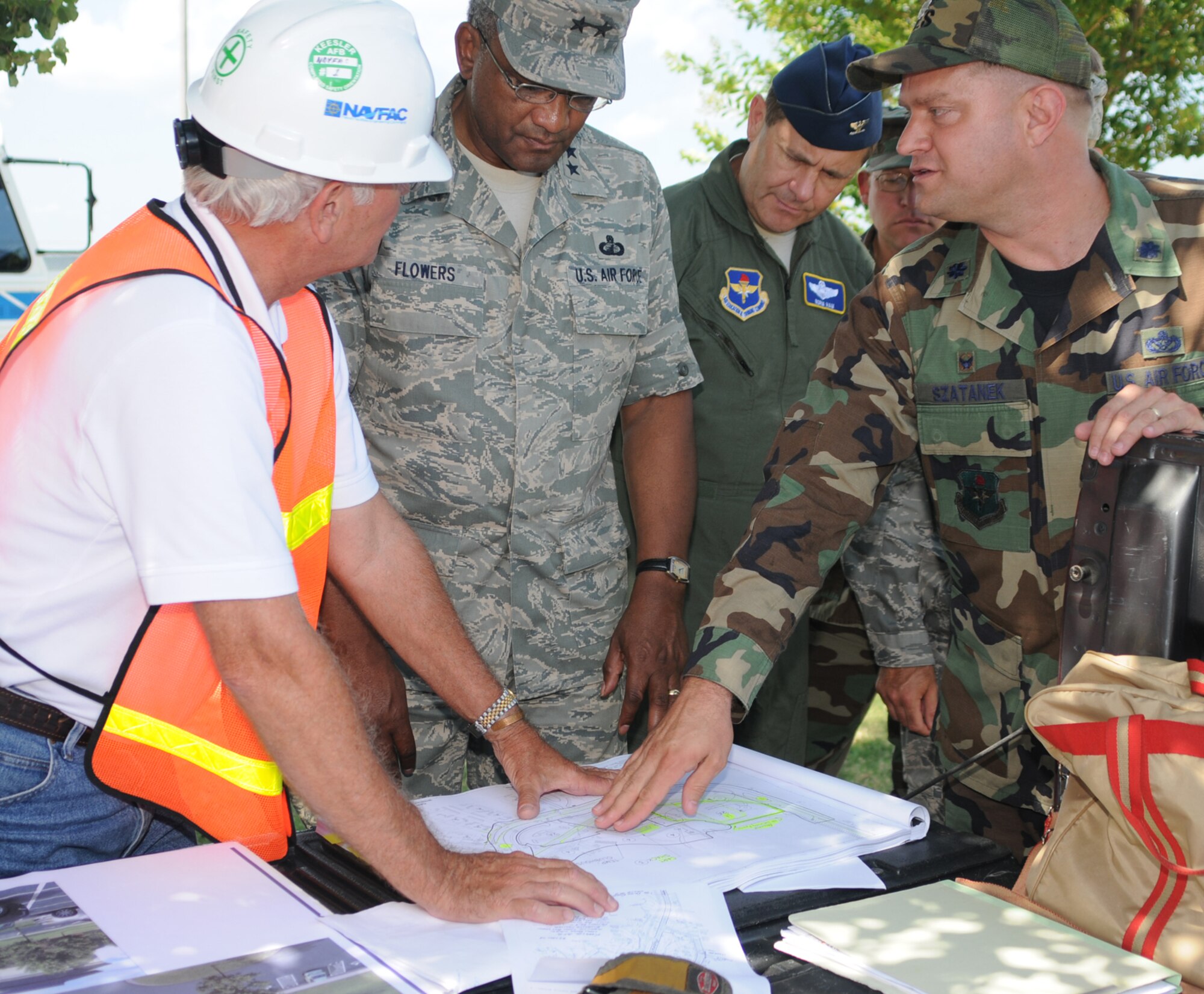 From left, Jerry Wages from the Naval Facilities Engineering Command’s office at Keesler goes over construction plans for the new events center with Maj. Gen. Alfred Flowers, new 2nd Air Force commander; Col. Norm Ham, 2nd Air Force, and Lt. Col. Jeff Szatanek, 81st Civil Engineer Squadron commander, during a familiarization tour May 3.  (U.S. Air Force phot by Kemberly Groue)
