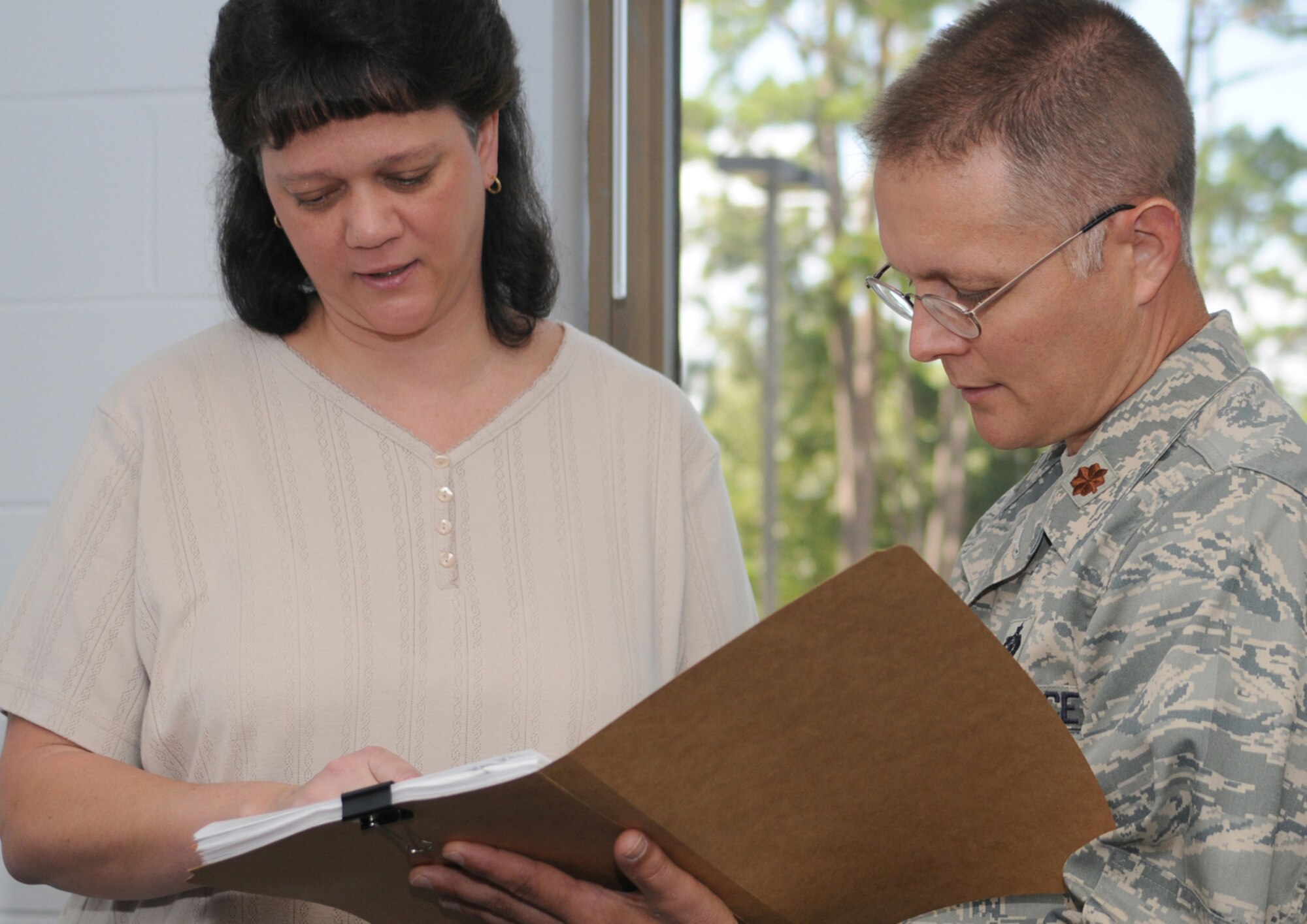 Secretary Sandy Potter, left, goes over staff summary sheets with Maj. Rich Cole, new commander of the 81st Force Support Squadron.  Major Cole, who’s been selected for promotion to lieutenant colonel, comes to Keesler from Air Force headquarters, where he was the executive officer for the Directorate of Force Development for the deputy chief of staff for manpower, personnel and services.  He took command June 5 from Lt. Col. Paul Valenzuela, who’ll be deployed to Southwest Asia for the next year.  (U.S. Air Force photo by Kemberly Groue)