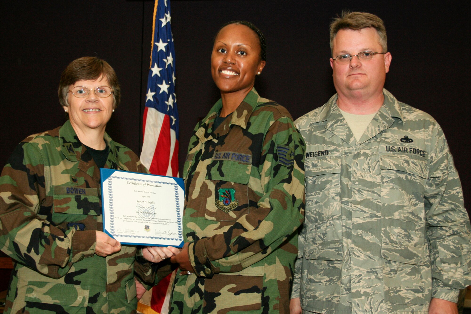 GRISSOM AIR RESERVE BASE, Ind., -- Janet Nalls, an intelligence craftsman with the 434th Operations Support Squadron, receives a certificate marking her promotion to technical sergeant. Presenting the certificate are Col. Betty Bowen, 434th Support Group commander, and Chief Master Sgt. Chad Weisend, 434th Maintenance Group superintendent. The presentation was made during the quarterly promotion ceremony. (U.S. Air Force photo/Tech. Sgt. Patrick Kuminecz)