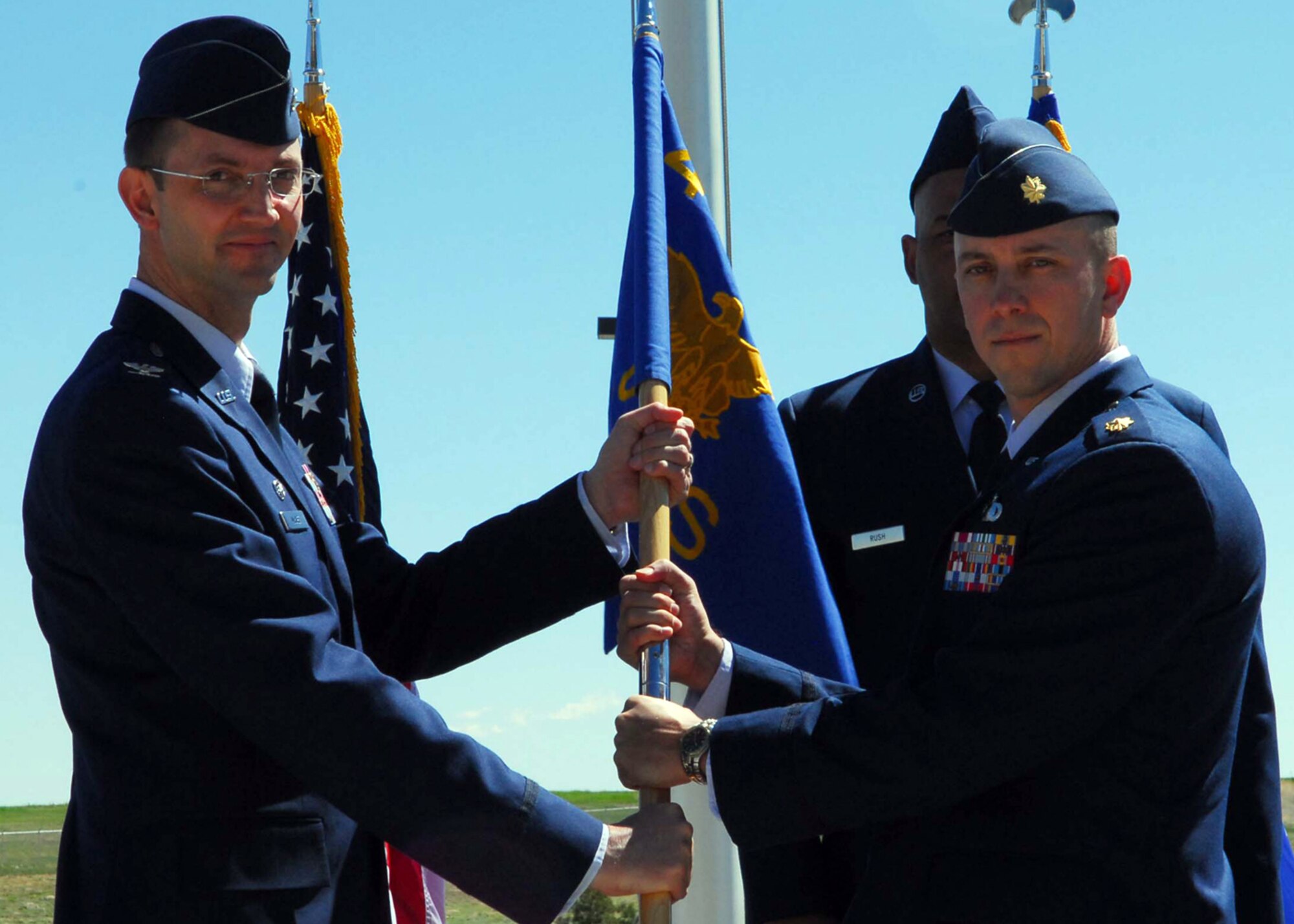 BUCKLEY AIR FORCE BASE, Colo. -- BUCKLEY AIR FORCE BASE, Colo. -- Maj. William Hunter assumes command of the 460th Comptroller Squadron from Col. Wayne McGee, 460th Space Wing commander, in a change of command ceremony here June 6. (U.S. Air Force photo by Airman 1st Class Alex Gouchnour)