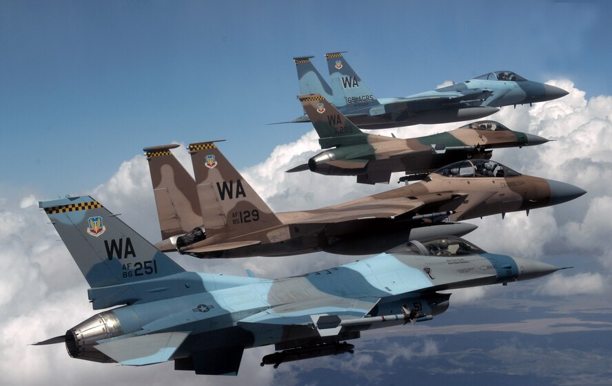 A flight of Aggressor F-15 Eagles and F-16 Fighting Falcons fly in formation 5 June over the Nevada Test and Training Ranges. The jets are assigned to the 64th and 65th Aggressor squadrons at Nellis Air Force Base, Nev. The F-15's superior maneuverability and acceleration are achieved through low wing-loading (the ratio of aircraft weight to its wing area), which is a vital factor in maneuverability and a high thrust-to-weight ratio, which enables the aircraft to turn tightly without losing airspeed. The F-16 can fly more than 500 miles (860 kilometers), deliver its weapons with superior accuracy, defend itself against enemy aircraft, and return to its starting point.  (U.S. Air Force photo/Master Sgt. Kevin J. Gruenwald)