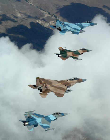 A flight of Aggressor F-15 Eagles and F-16 Fighting Falcons fly in formation June 5 over the Nevada Test and Training Range. The jets are assigned to the 64th and 65th Aggressor squadrons at Nellis Air Force Base, Nev. The F-15 has electronic systems and weaponry to detect, acquire, track and attack enemy aircraft while operating in friendly or enemy-controlled airspace. The F-16 can locate targets in all weather conditions and detect low-flying aircraft in radar ground clutter. (U.S. Air Force photo/Master Sgt. Kevin J. Gruenwald) 