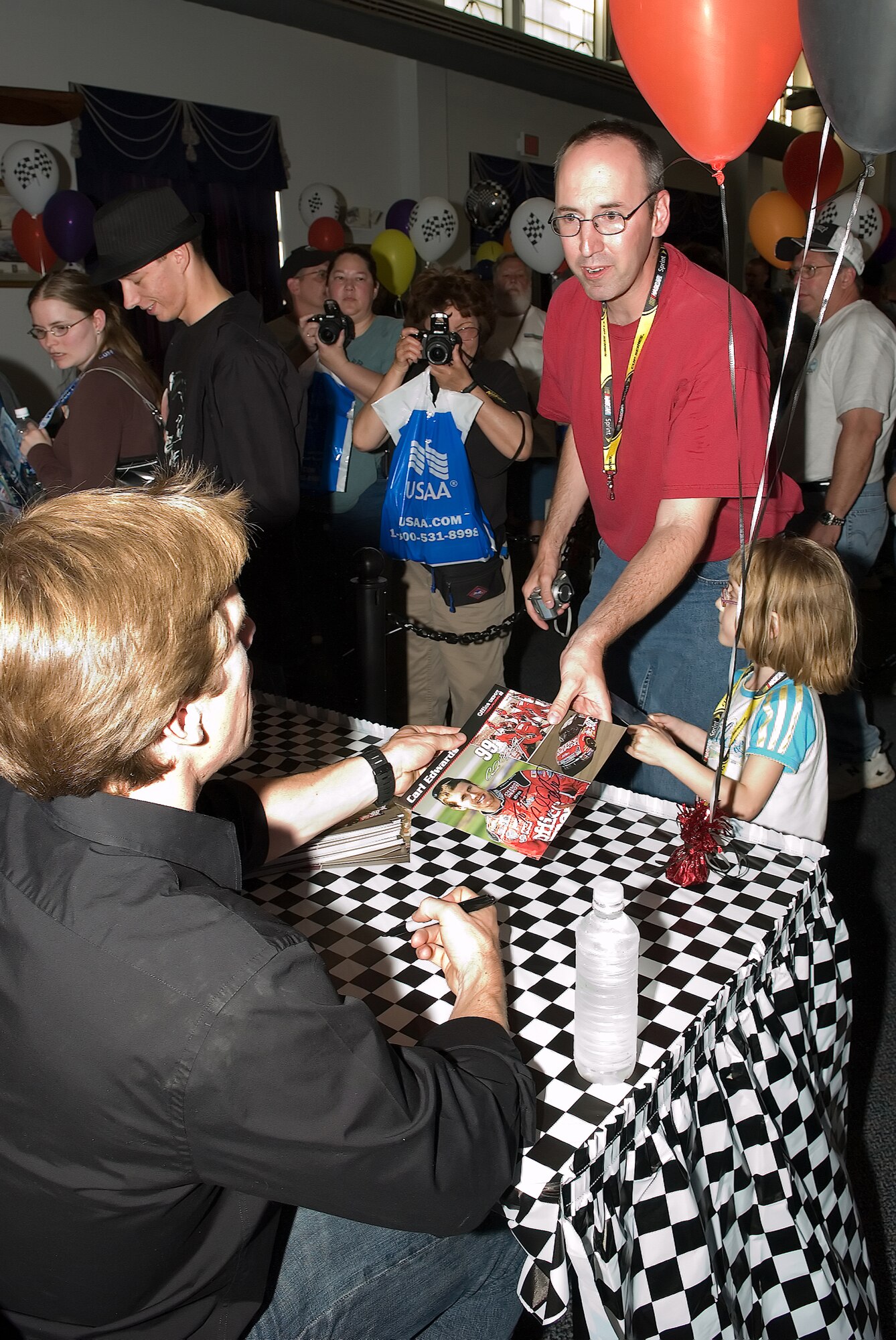 Master Sgt. John Kirby, 436th Operations Support Squadron, asks NASCAR driver Carl Edwards for his autograph at the NASCAR Social May 30 at The Landings Club.  Mr. Edwards was one of several NASCAR drivers present at the social to sign autographs.  (U.S. Air Force Photo/Jason Minto)