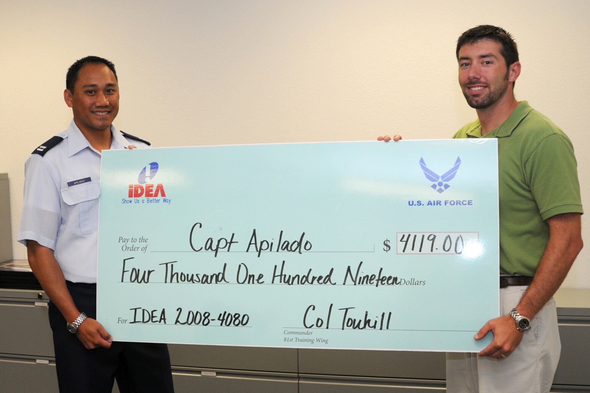 Capt. Darrell Apilado, left and Mr. John Slusher, 81 MSS pose with the check that was presented to Capt. Apilado.  (U.S. Air Force photo by Kemberly Groue)