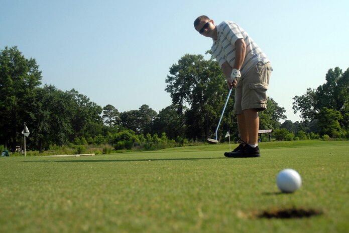 Jeff Walker sinks a putt at the putting green at the Wrenwoods Golf Course June 9. Every Monday after 3 p.m. during June and July, Team Charleston members can enjoy nine holes of golf for $5 during the Wrenwoods "ParTake" summer golf promotion. Advance reservations are required and the price includes green fees, cart, range balls and rental clubs if needed. Call the clubhouse at 963-1833 for more information. (U.S. Air Force photo/Senior Airman Sam Hymas)
