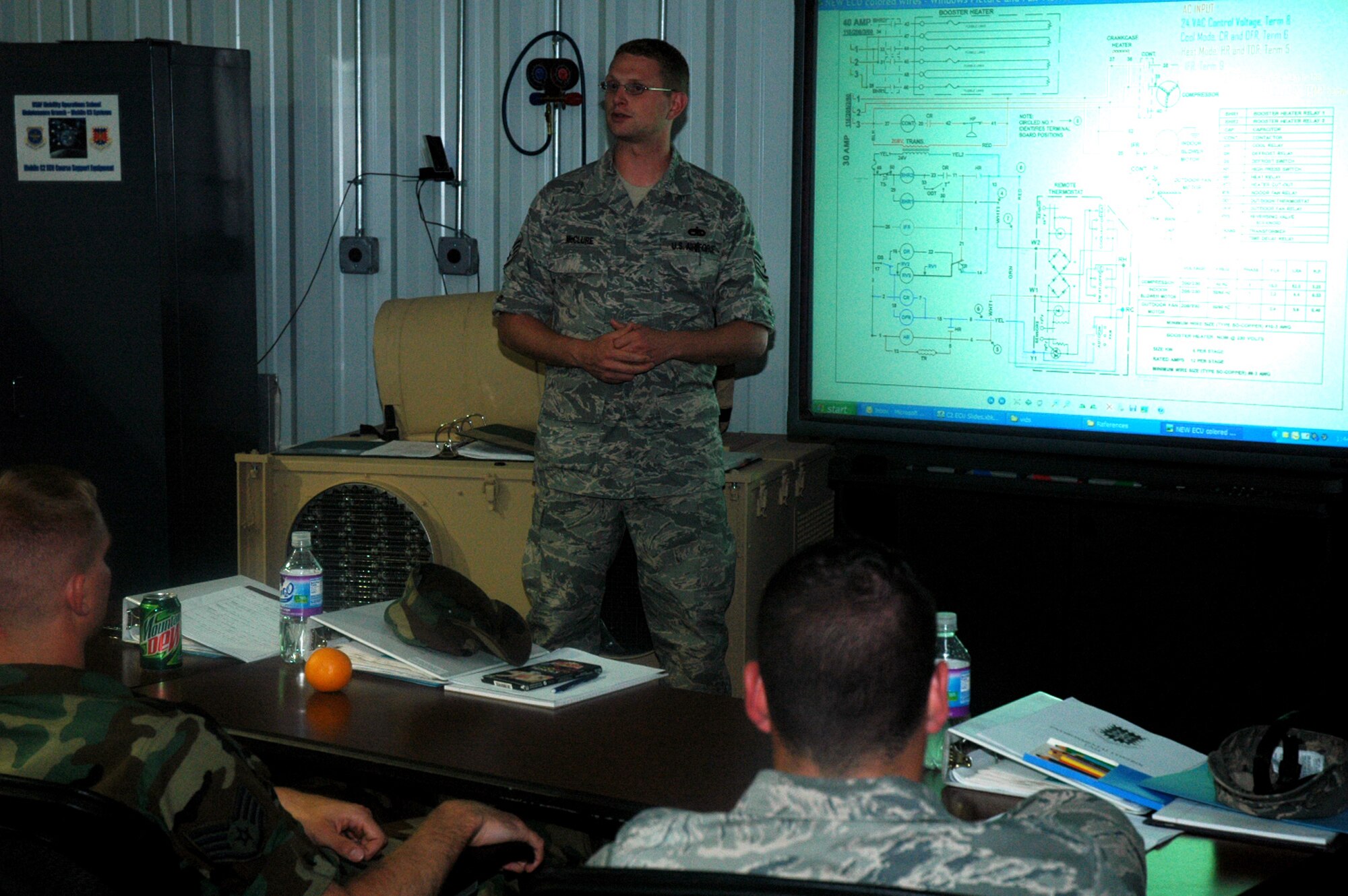 Staff Sgt. Jonathon McClure, instructor and course director for the Mobile Command and Control Environmental Control Unit Course for the U.S. Air Force Expeditionary Center's Mobility Operations School at Fort Dix, N.J., goes over technical data with his students during a class June 5, 2008, at the Center.  Nearly all of Sergeant McClure's students come from contingency response units from across the Air Force.  Annually, the USAF EC trains more than 23,000 students in expeditionary- and mobility air force-based courses both with in-residence and distance learning.  (U.S. Air Force Photo/Tech. Sgt. Scott T. Sturkol)