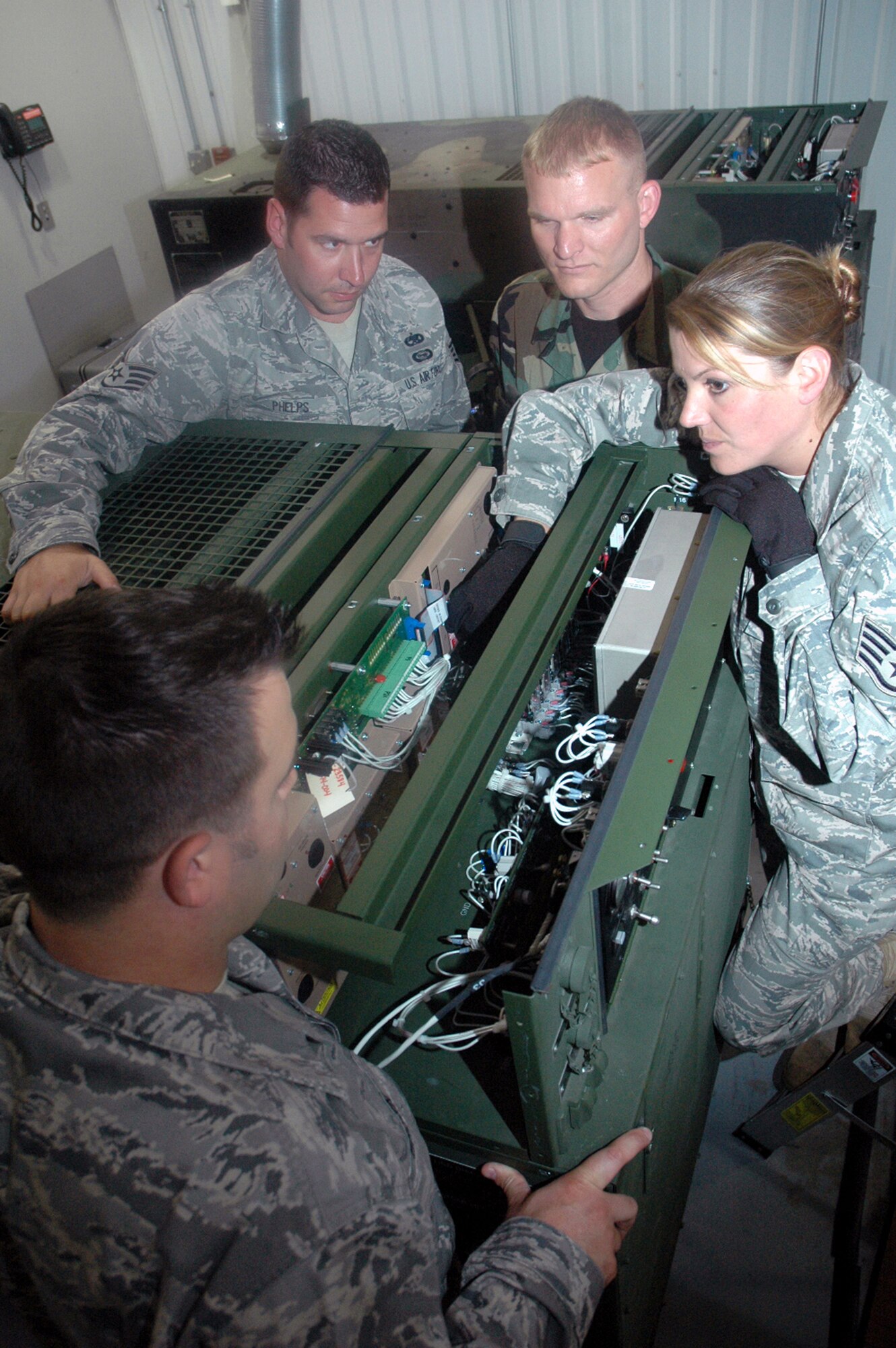 Staff Sgt. Jamie Widrig (right), instructor and course director for the Mobile Command and Control Generator Course for the U.S. Air Force Expeditionary Center's Mobility Operations School at Fort Dix, N.J., shows students in her course the basics for a generator June 5, 2008, at the Center.  Annually, the USAF EC trains more than 23,000 students in expeditionary- and mobility air force-based course both with in-residence and distance learning.  (U.S. Air Force Photo/Tech. Sgt. Scott T. Sturkol)